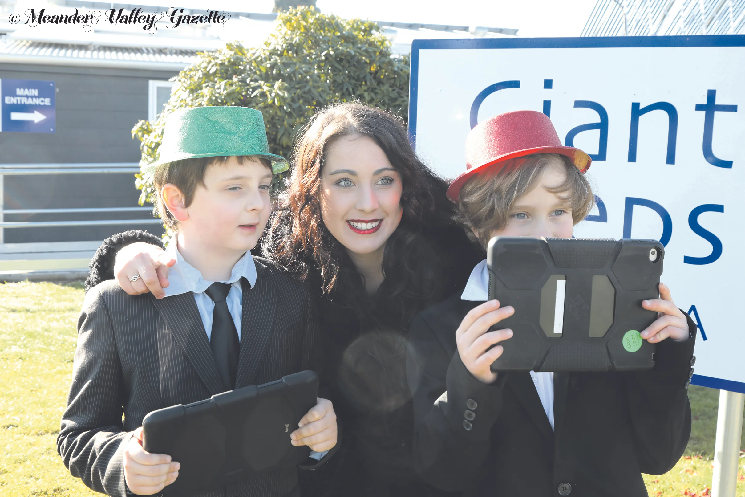 Jasper Dorman in the green hat, Elliot Bartninkaitis in the red hat, with movie group teacher Danielle Whatley in the middle. Photo by Mike Moores