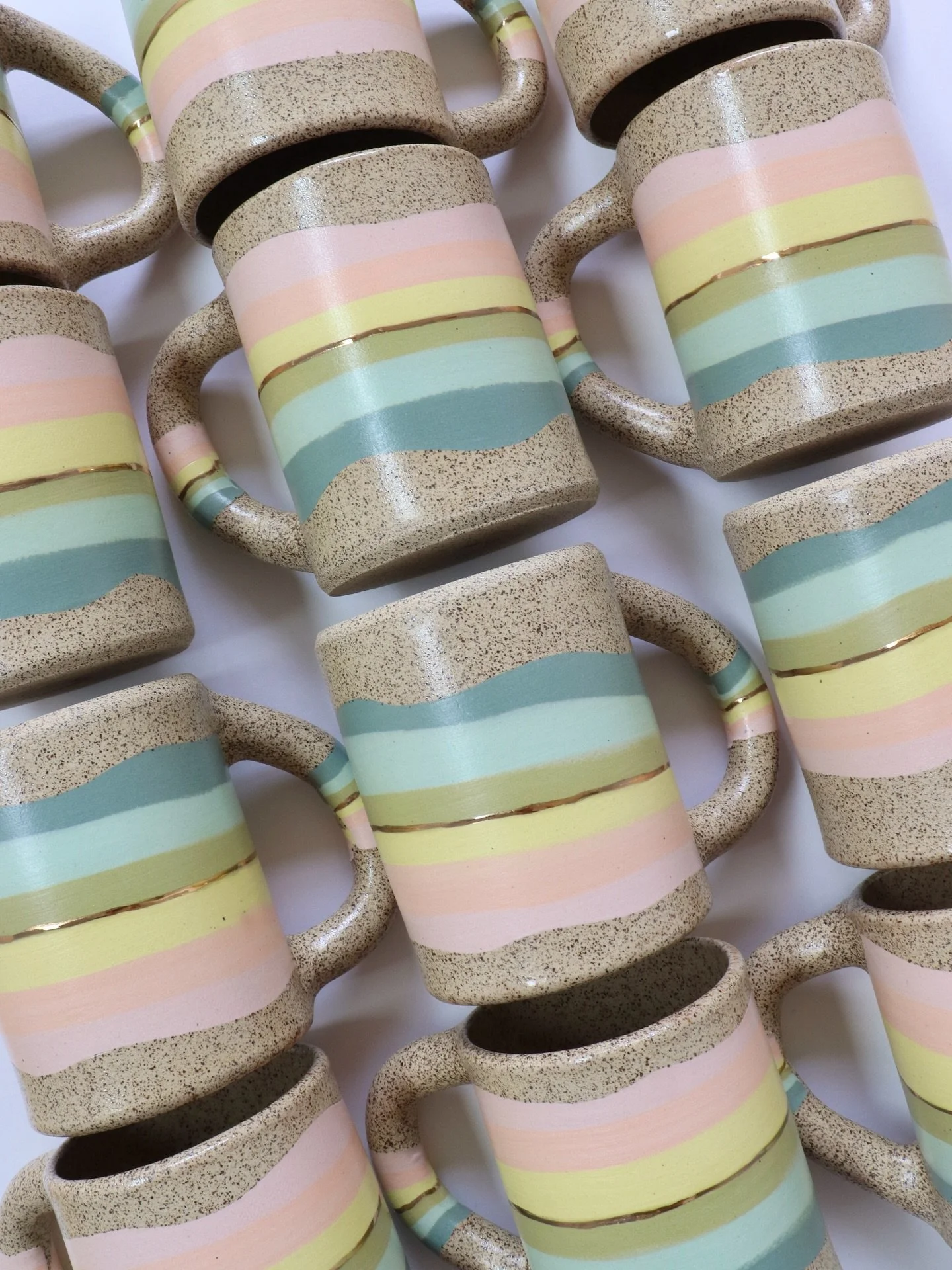 I&rsquo;ve been working on making many colorful mugs! A slightly updated version of an older color palette. These are hand built from tinted clay I mix using nerikomi/inlay techniques with a touch of real gold luster✨. A labor of love.🤍
Catch these 