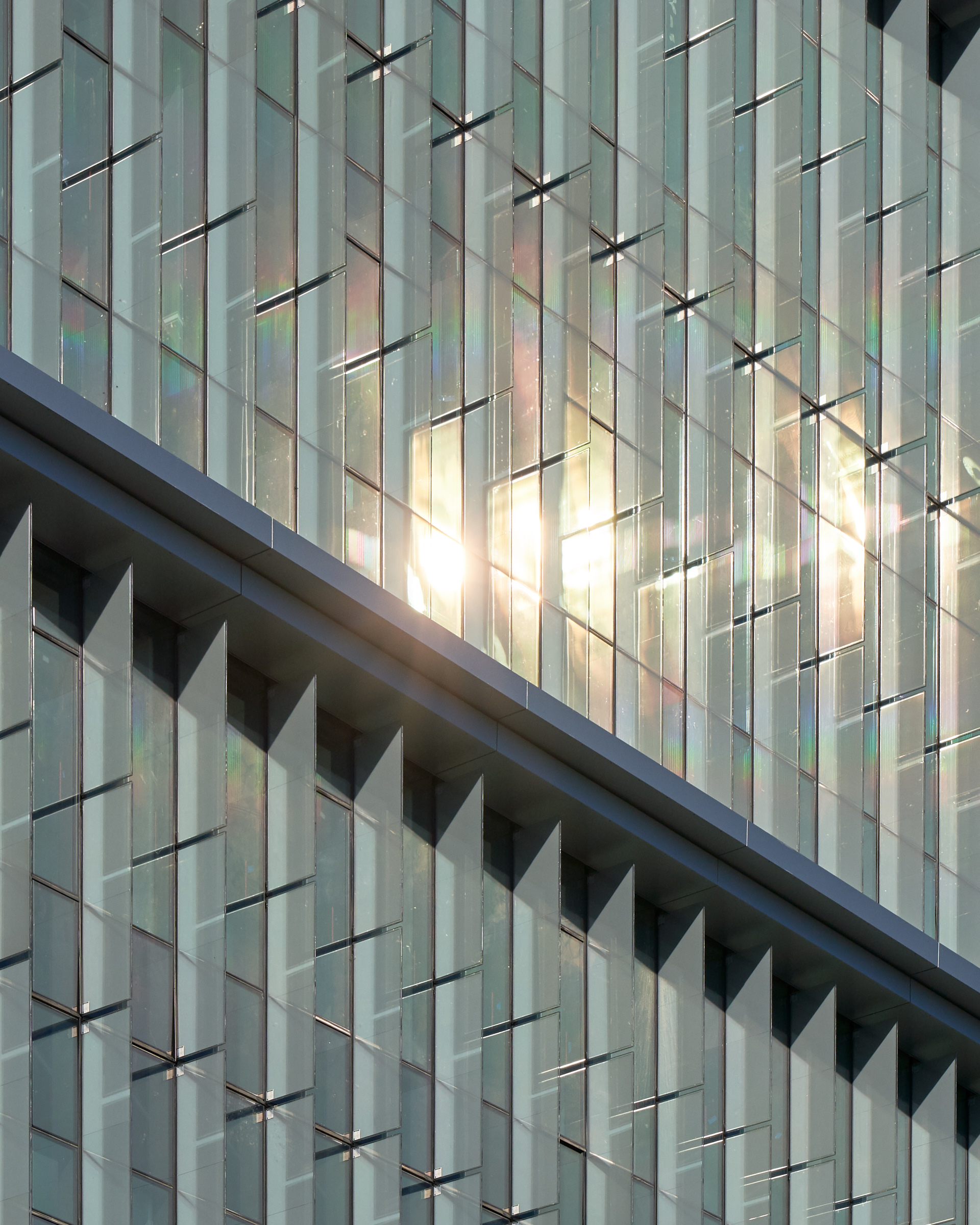 Northwest orientation of glass solar fins: shading reduces solar heat gain from low afternoon sun in summer