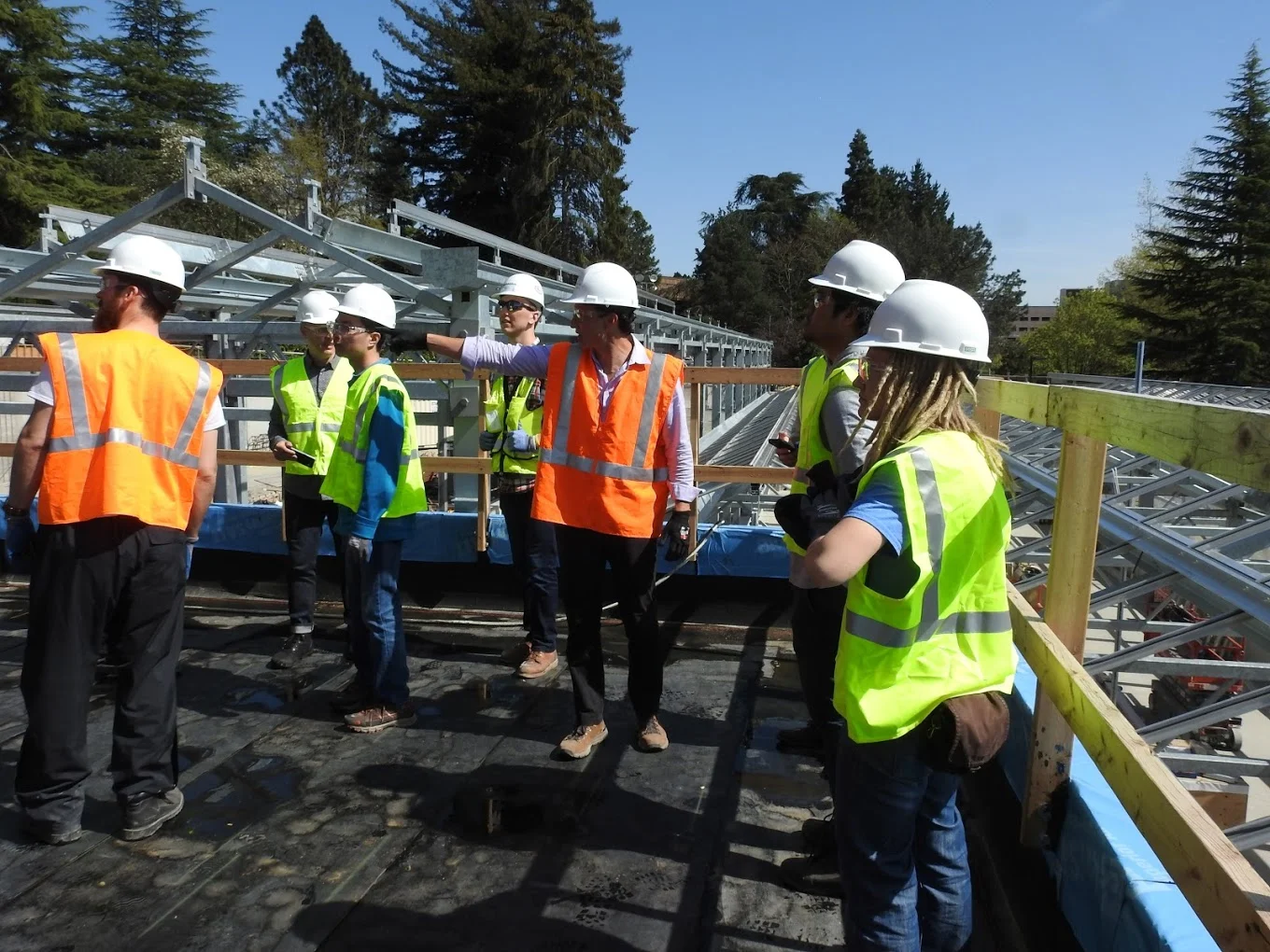 University of Washington Solar Student Group on a construction tour witnessing installation of innovative sustainable systems they helped initiate during design and fund with grants.