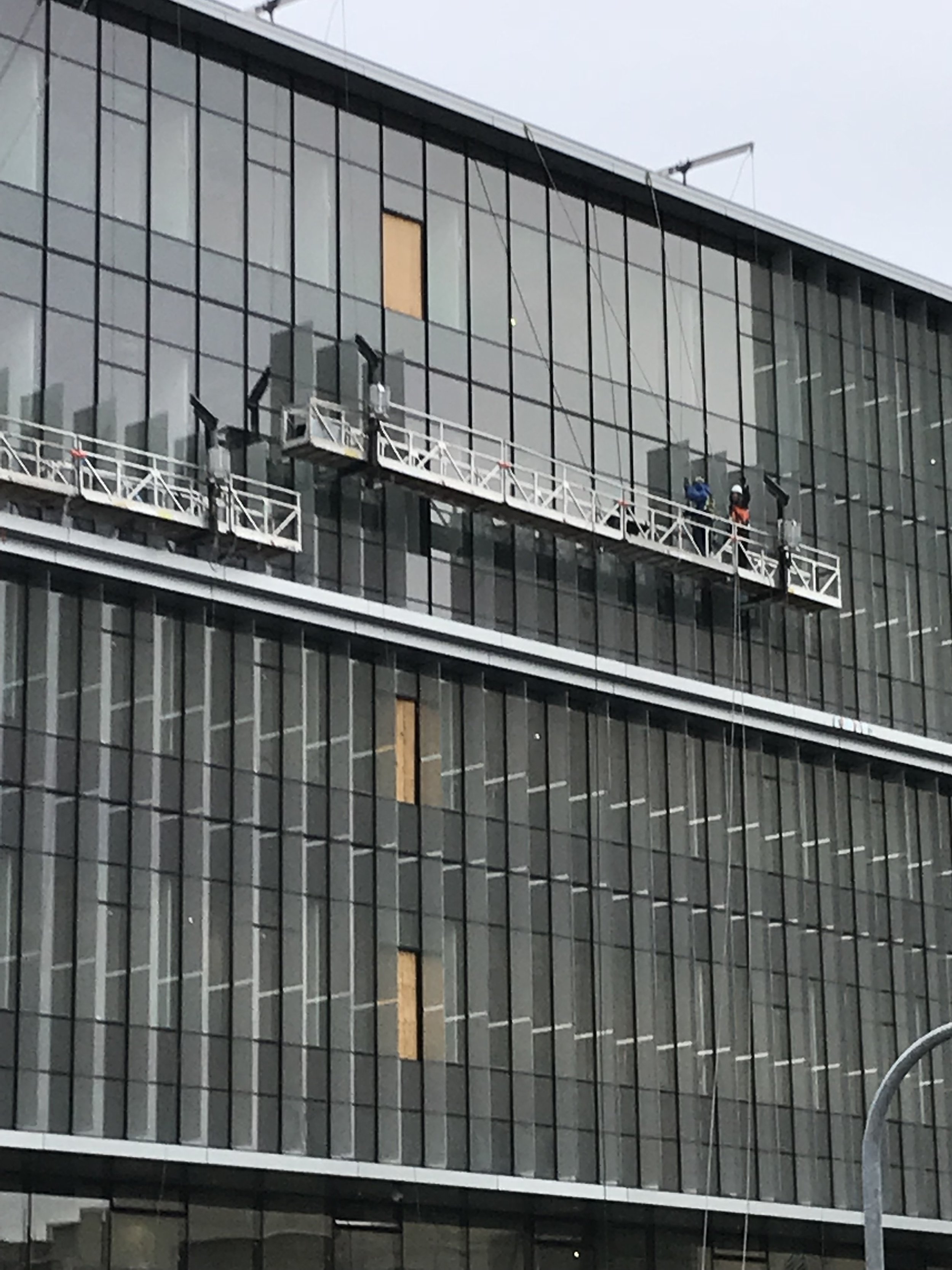 Glass solar fin installation in progress