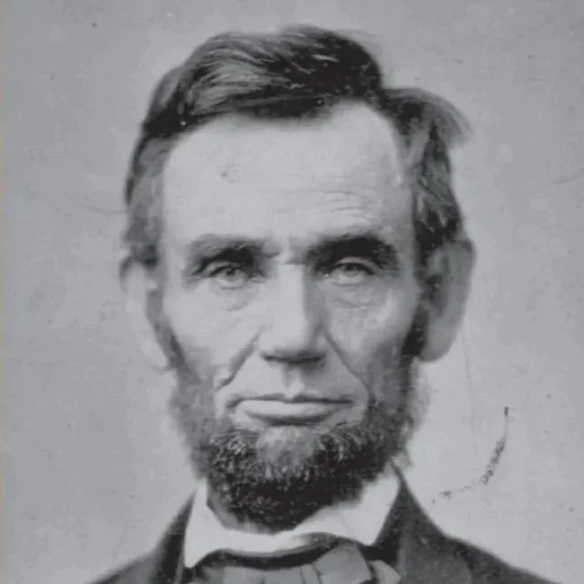 A black and white historical portrait of Abraham Lincoln with a distinctive beard and serious expression.
