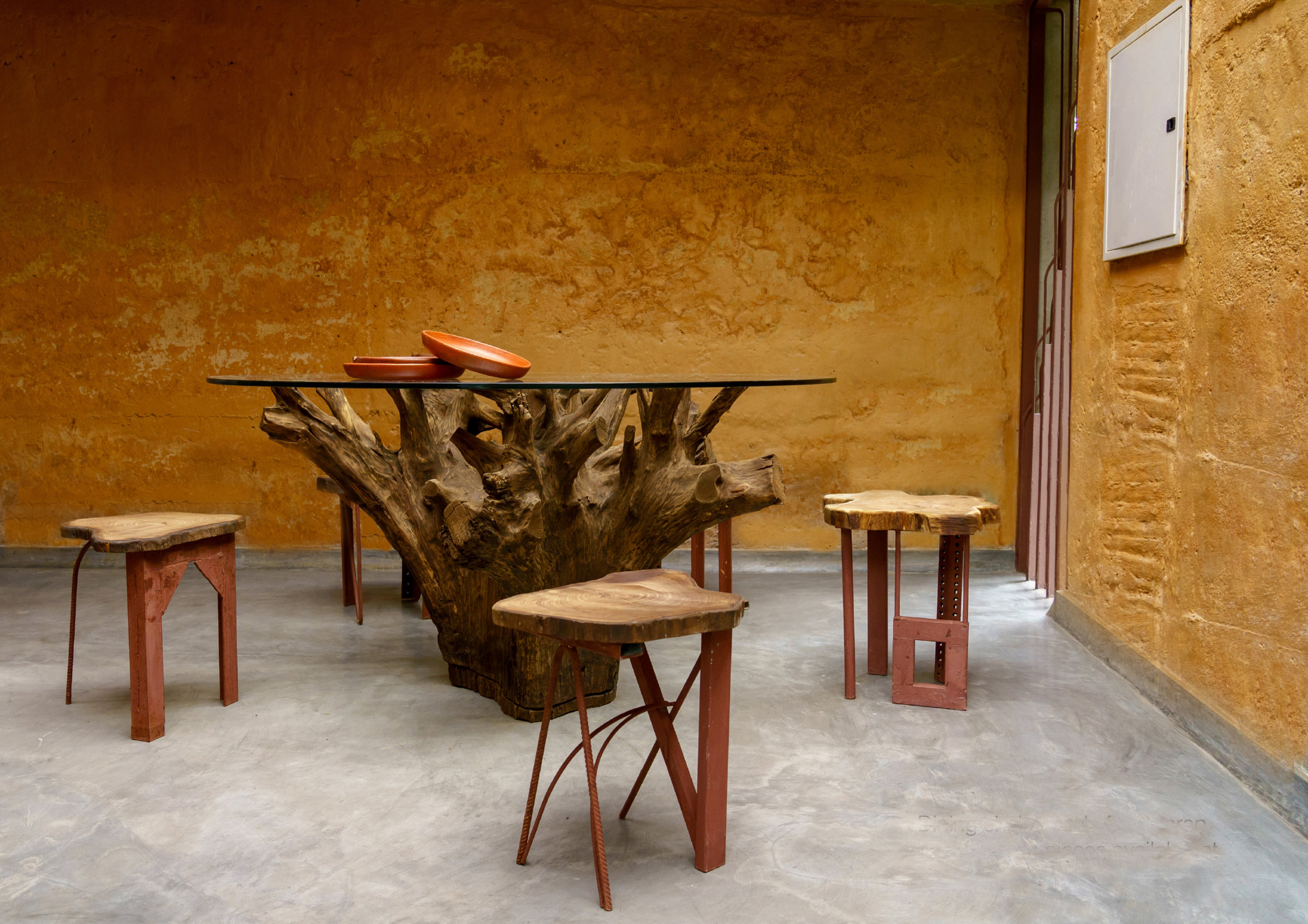 Dining Table made from the root of a tree and chairs made from scrap available at site.