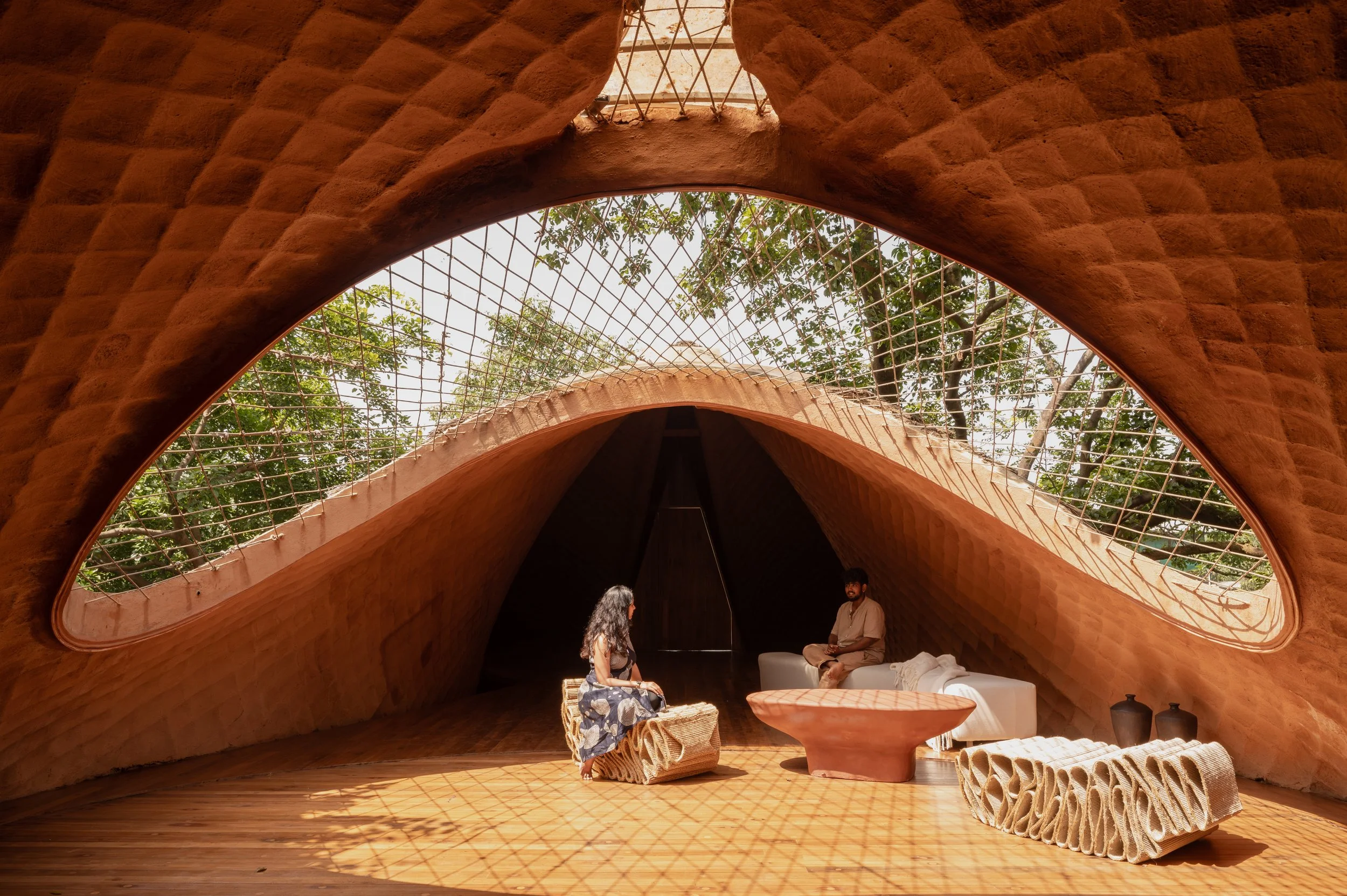  The thatch layer inspired by the scales of a pangolin, providing thermal insulation and effective cooling also allowed us to push for a long-span, lightweight structure with just 4 footings, ensuring very less intrusion into the natural contour of t