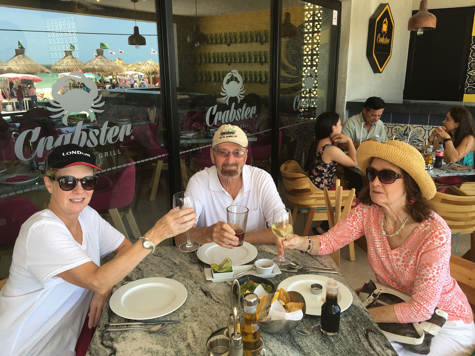 Cheers at the table at Crabster's in Progreso