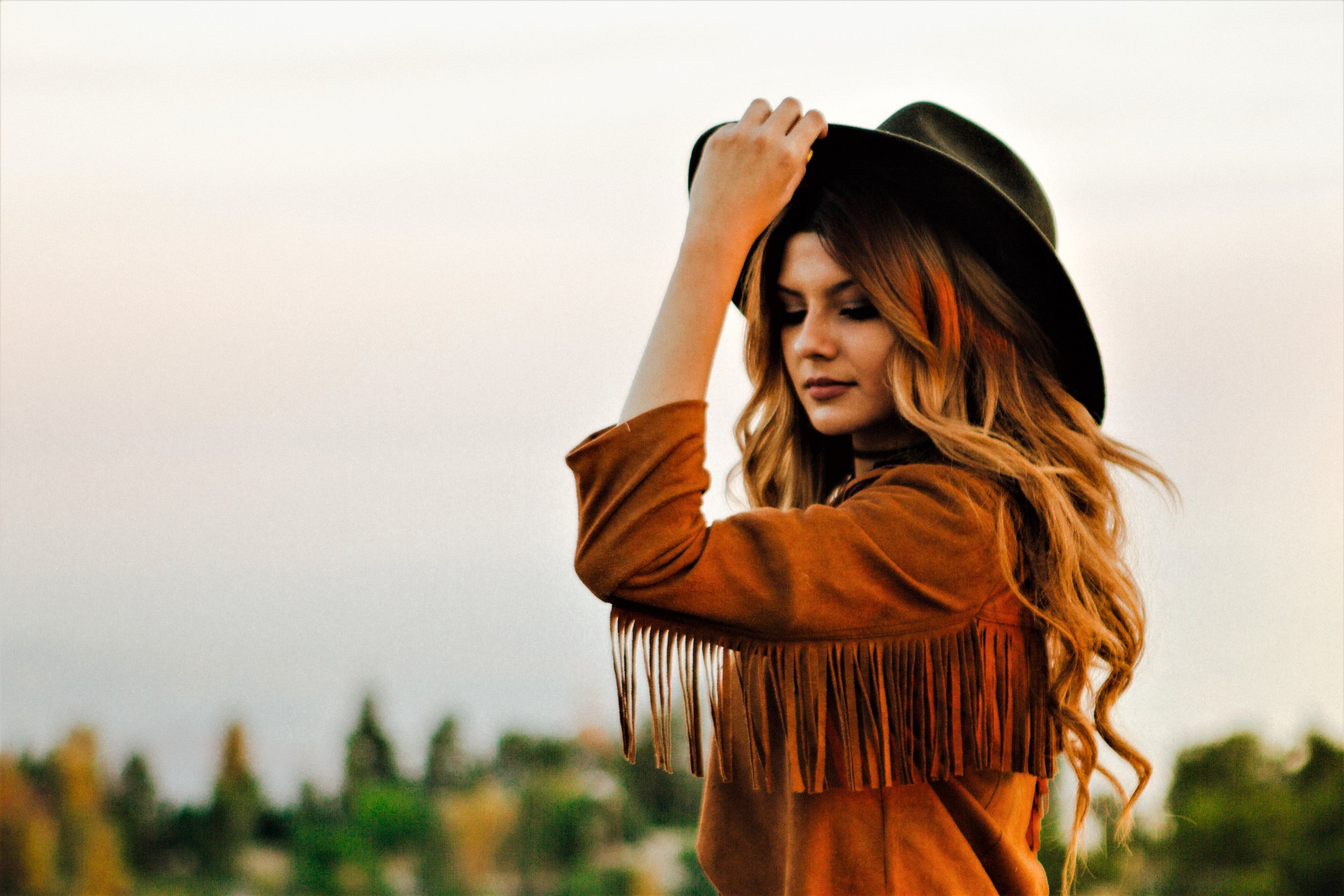 Cowgirl in hat and fringe jacket