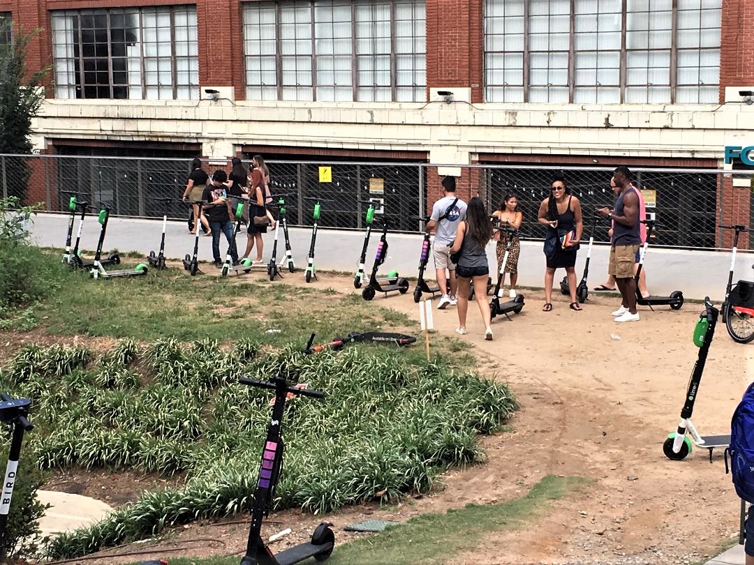 Scooters and bikes pulling up to Ponce City Market on the Beltline