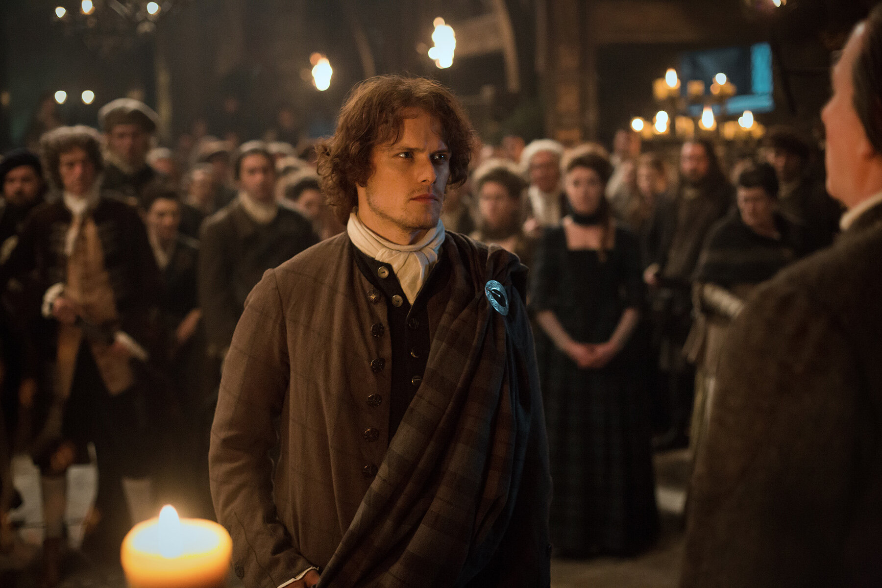 Jamie at the gathering speaks with the leader Colum MacKenzie in Outlander