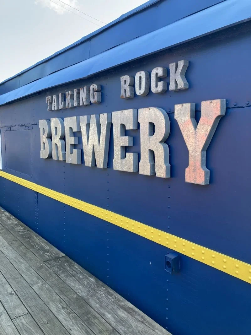 The colorful train car exterior of Talking Rock Brewery