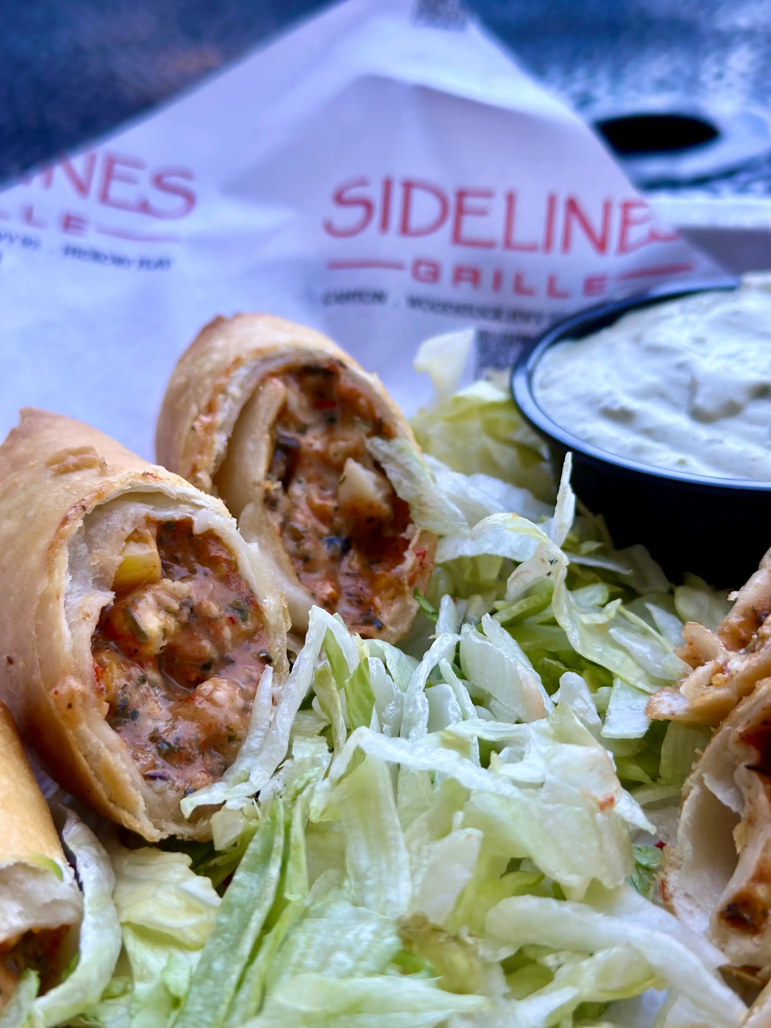 Egg rolls on a plate at Sidelines Grill