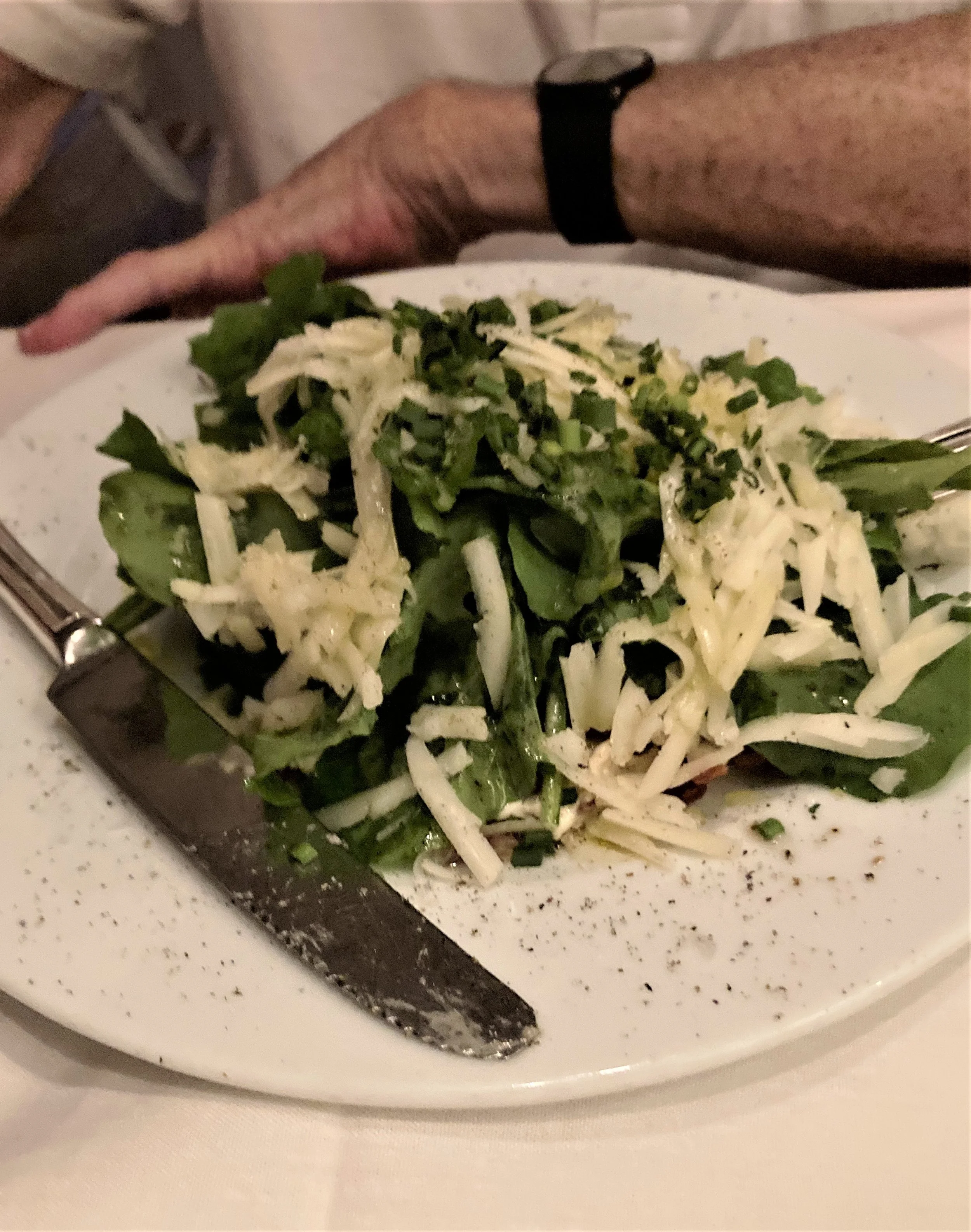 Beef carpaccio with arugula on top