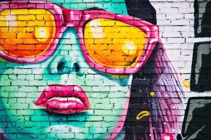 Colorful mural of girl in pink sunglasses