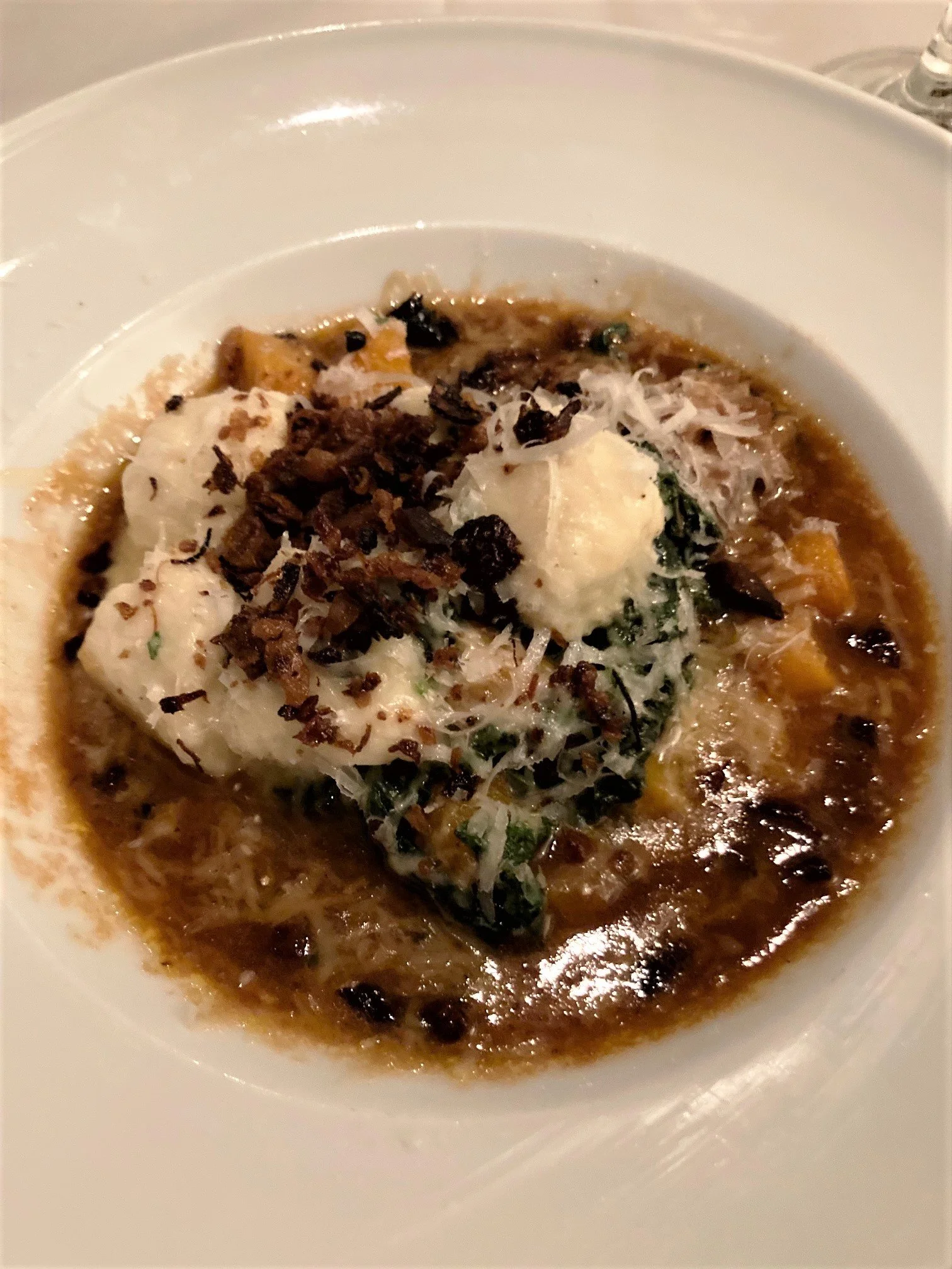 Duck confit with ricotta cheese gnocchi in a bowl