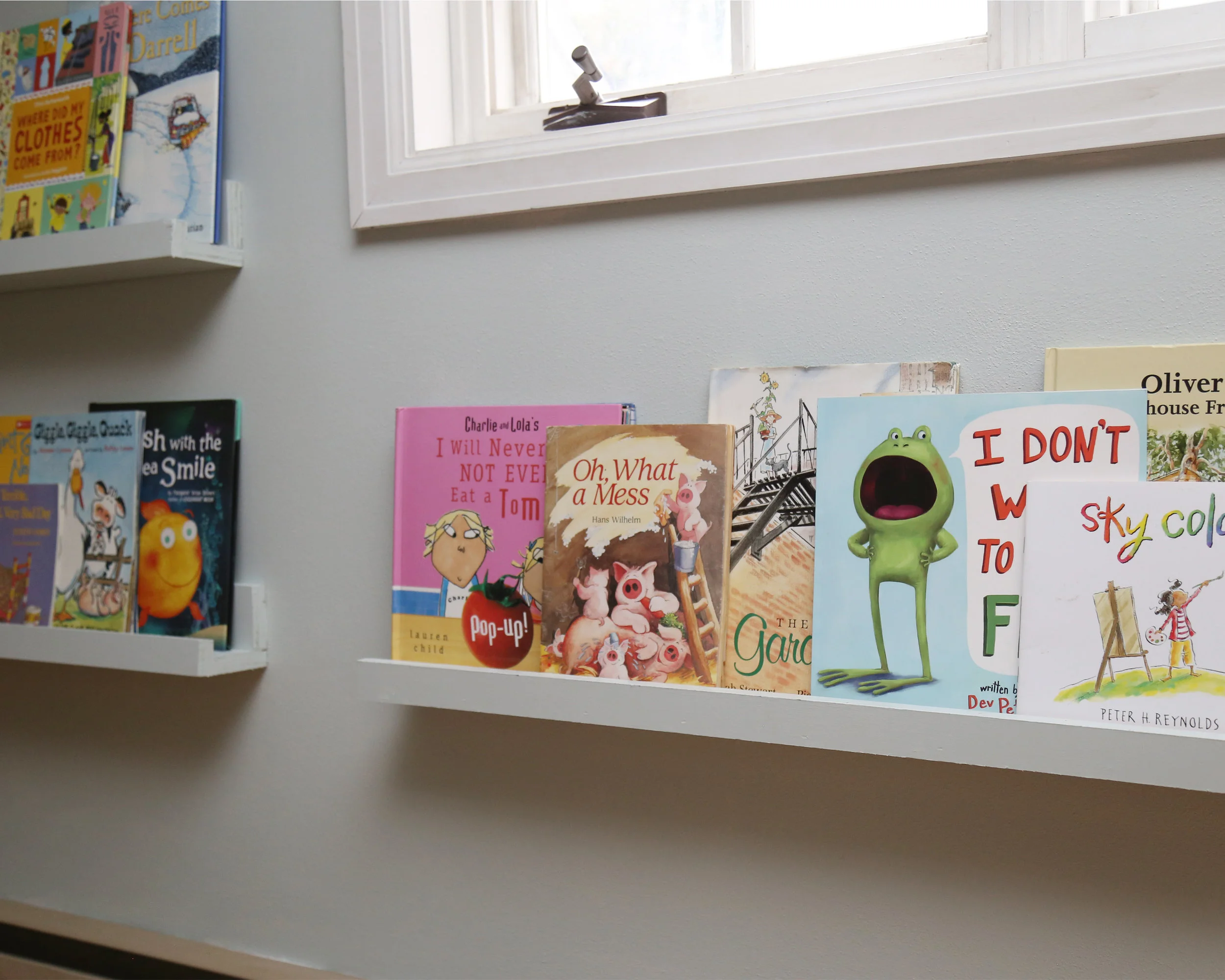 Brady built book ledges to hang on the wall with the dormer window and I painted them the same color as the wall to blend in. They are the perfect height for little ones to reach.