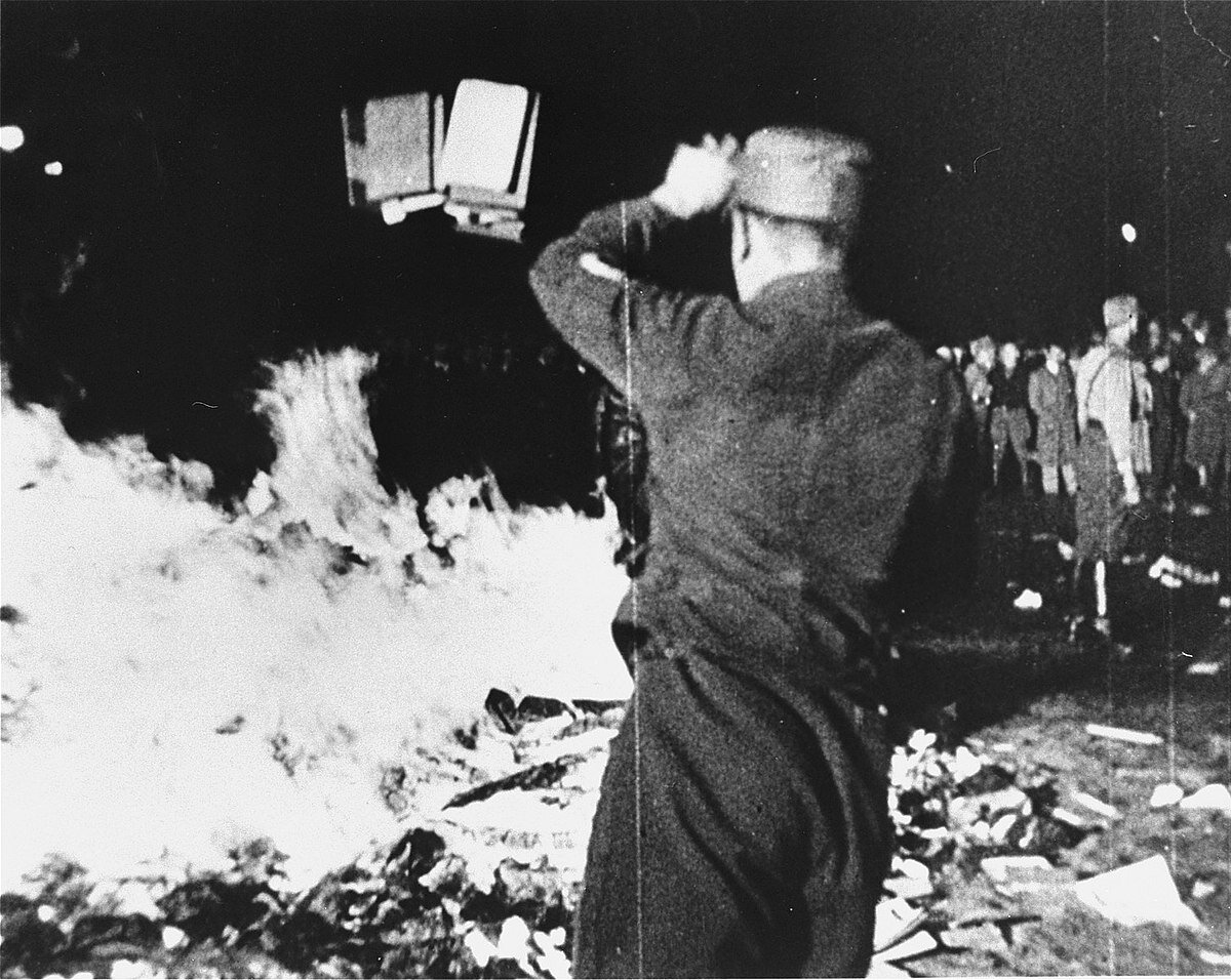 The burning of the library at the Institute for the Science of Sexuality - On May 6th, 1933, the German Student Union, one of the Youth Wings of Hitler’s Nazi movement, made a coordinated attack against the Institute due to its purpose of being a place of higher learning about LGBTQIA+ experiences. 12,000 - 20,000 documents of the Institute’s library were publicly hauled into the street and burned while Joseph Goebbels gave a speech to a crowd of 40,000 nazis. This mass burning was a massive act of erasure of transgender and queer history. 