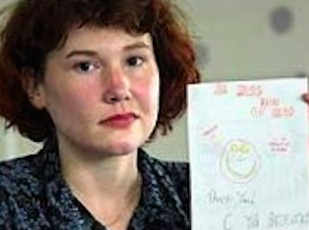 Maxine Carr holding up the card Holly Wells made for her (source: Wikipedia)