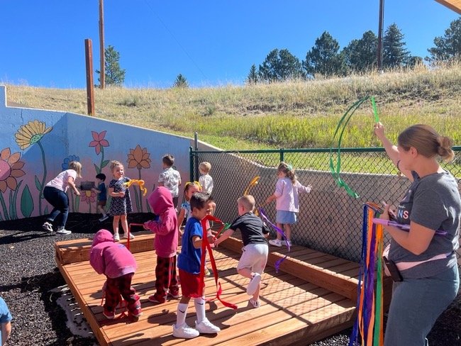 kids playing together in outdoor classroom