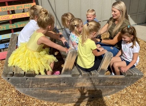 parent playing with children at preschool