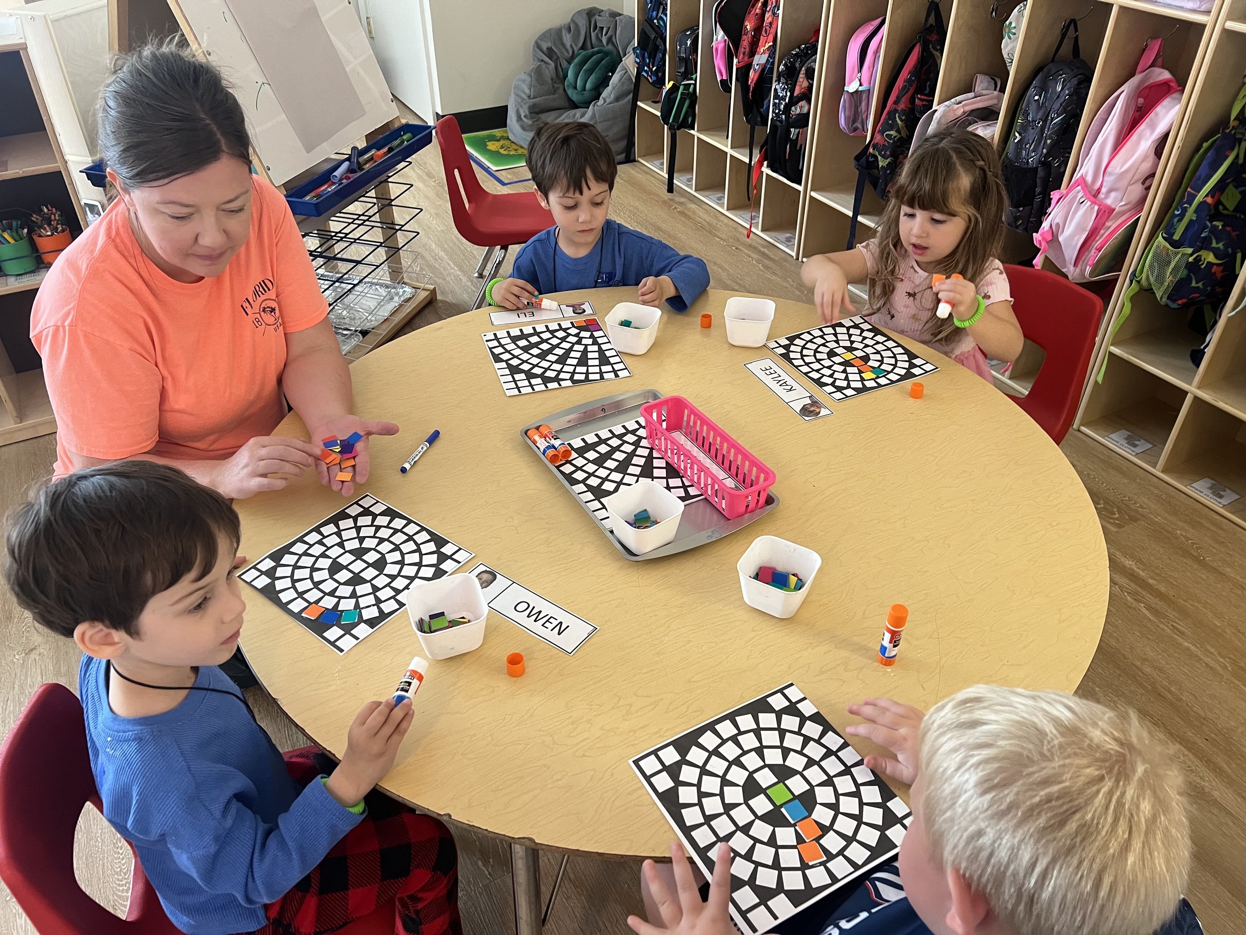 parent playing with children at preschool