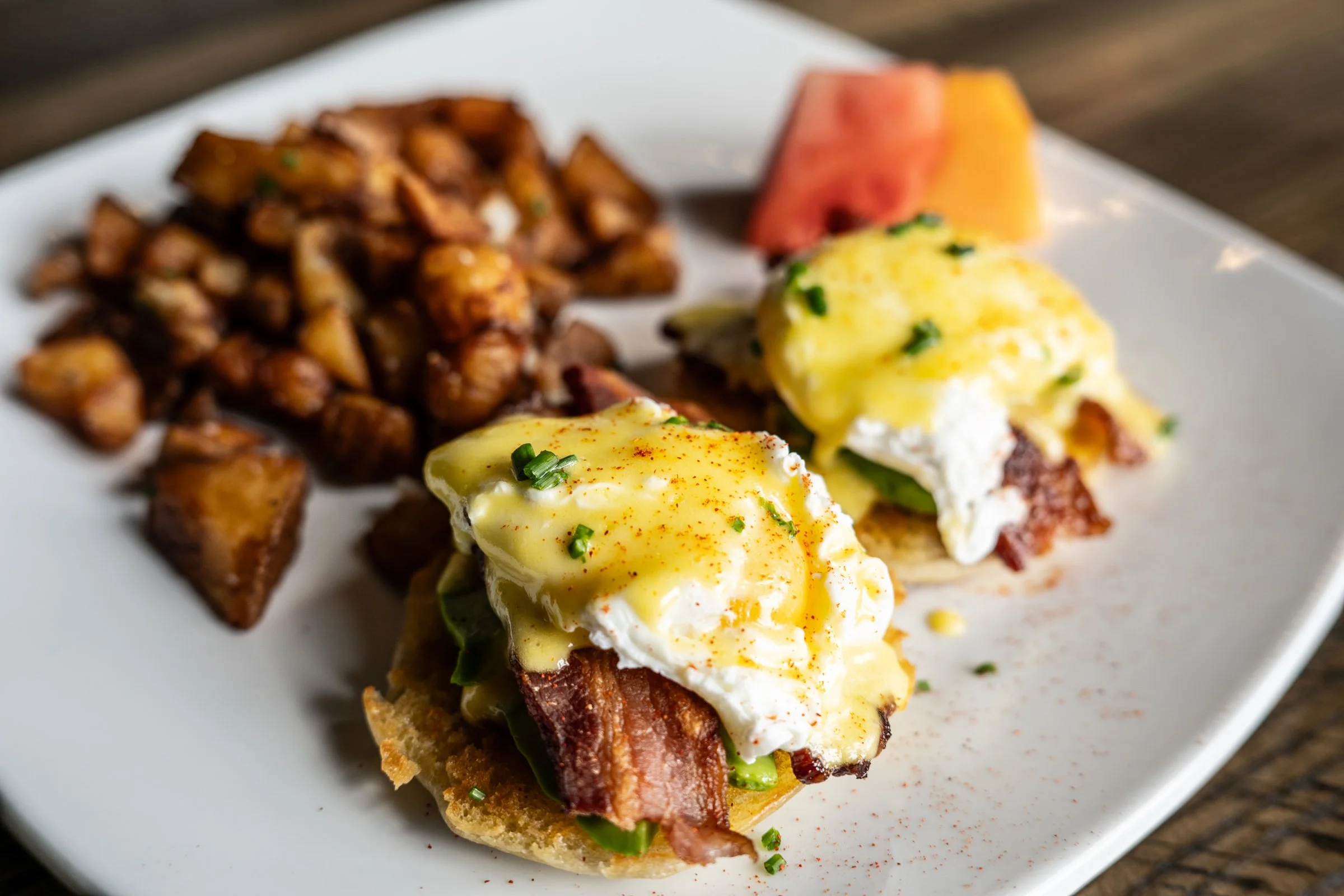 apple-wood bacon, avocado, poached eggs,  toasted english muffins, house-made hollandaise,  herb-roasted potatoes