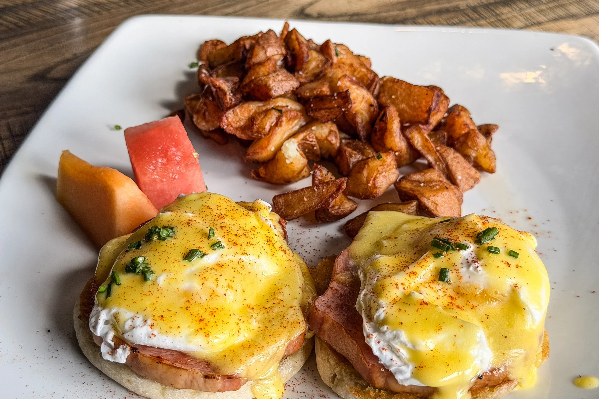thick-cut canadian bacon steak, poached eggs,  toasted english muffins, house-made hollandaise,  herb-roasted potatoes