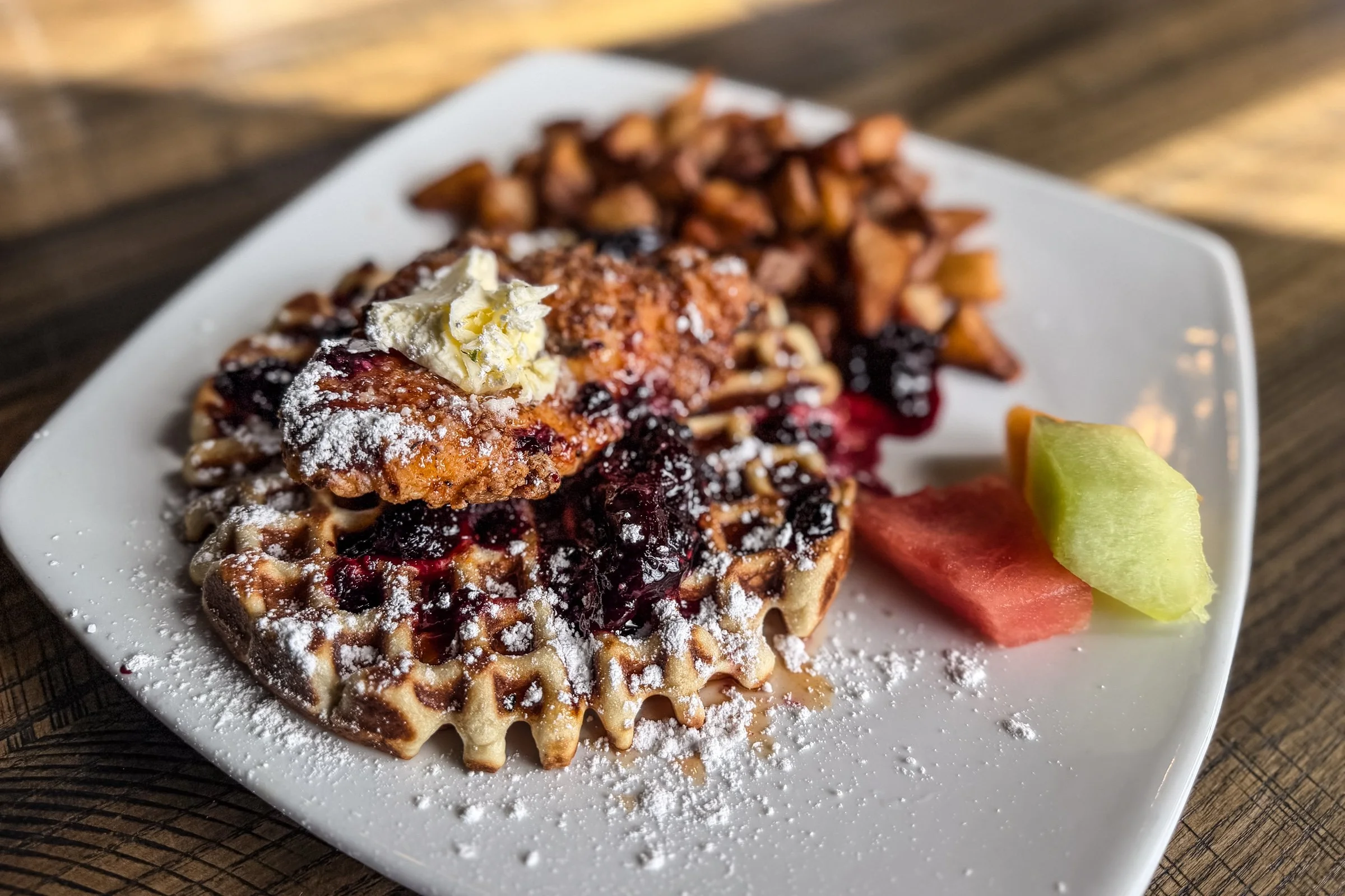 buttermilk southern fried chicken breast, hot honey drizzle, house-made waffle, powdered sugar, whipped butter, wild berry jam, herb-roasted potatoes