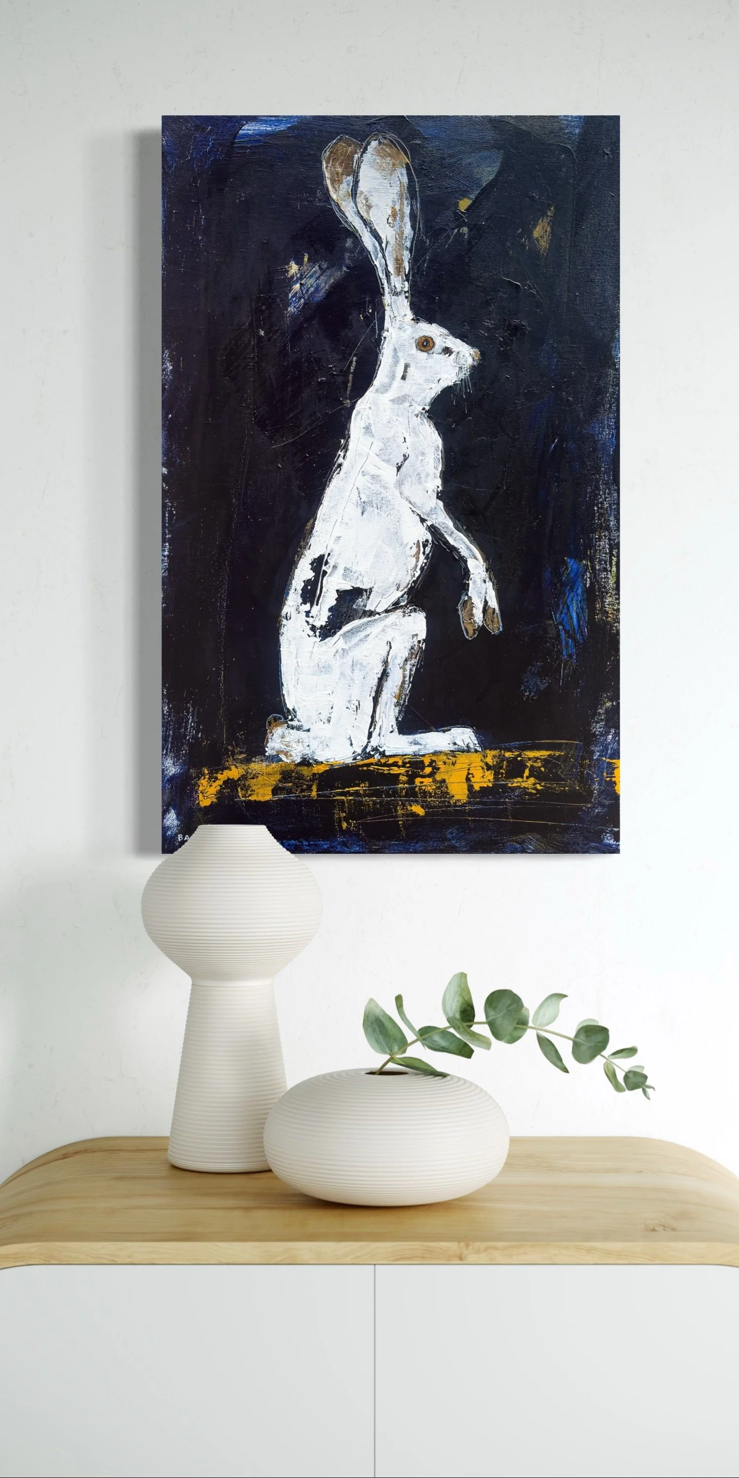White hare acrylic wildlife art hung above cabinet.