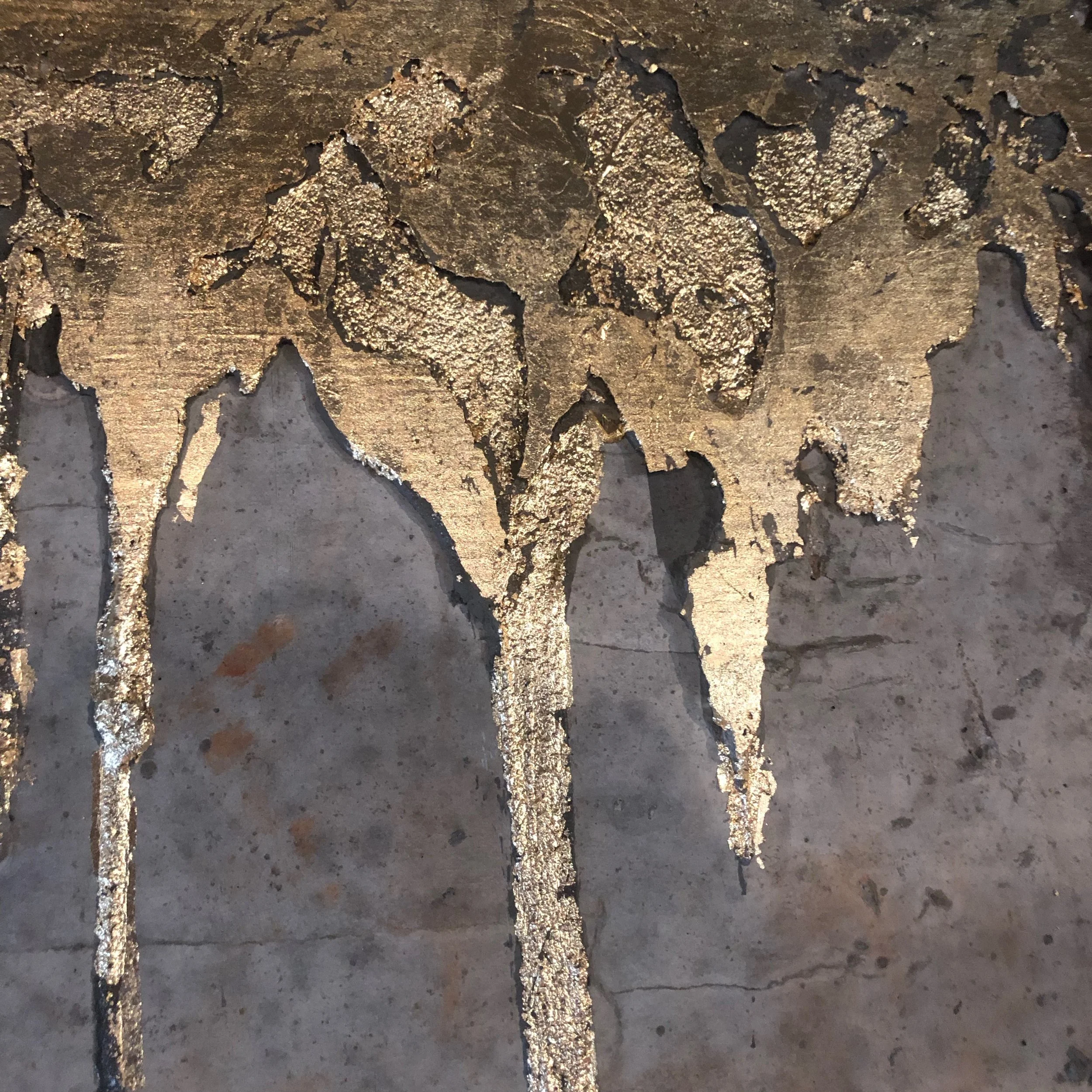 gilding at the columns on mezzanine. gold leaf on concrete