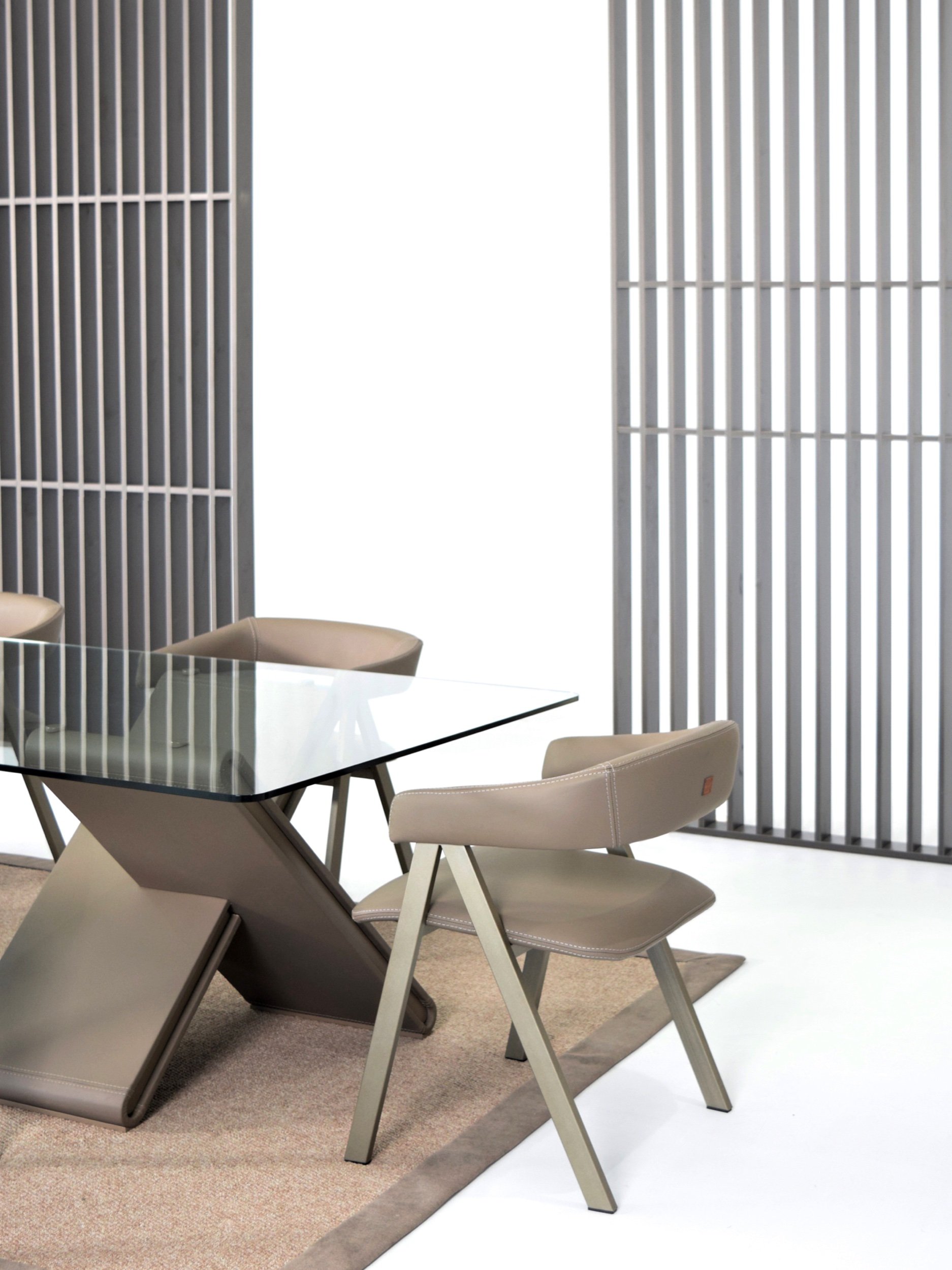 Close up view of Antonia leather dining chairs in a modern dining space