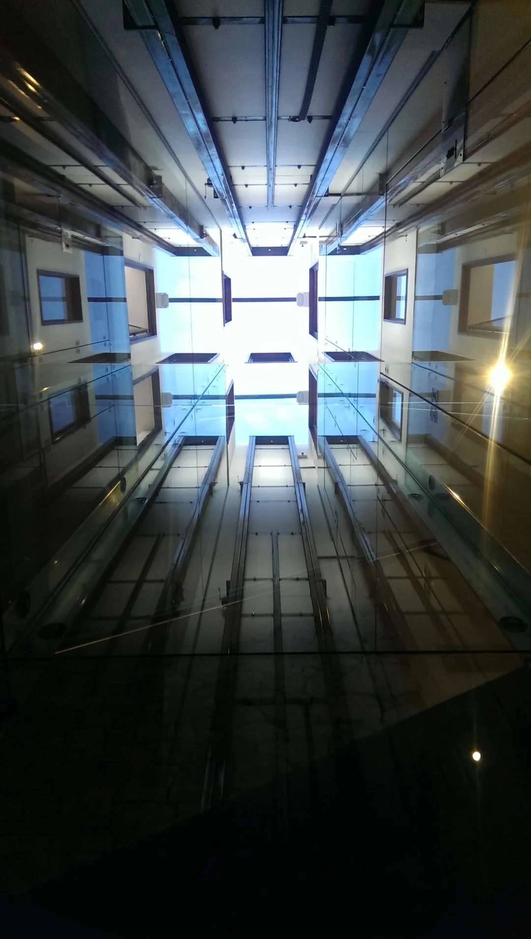 Backlit glass etched poem showcased in lift