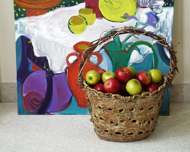 "Pot with apples in front of Painting"