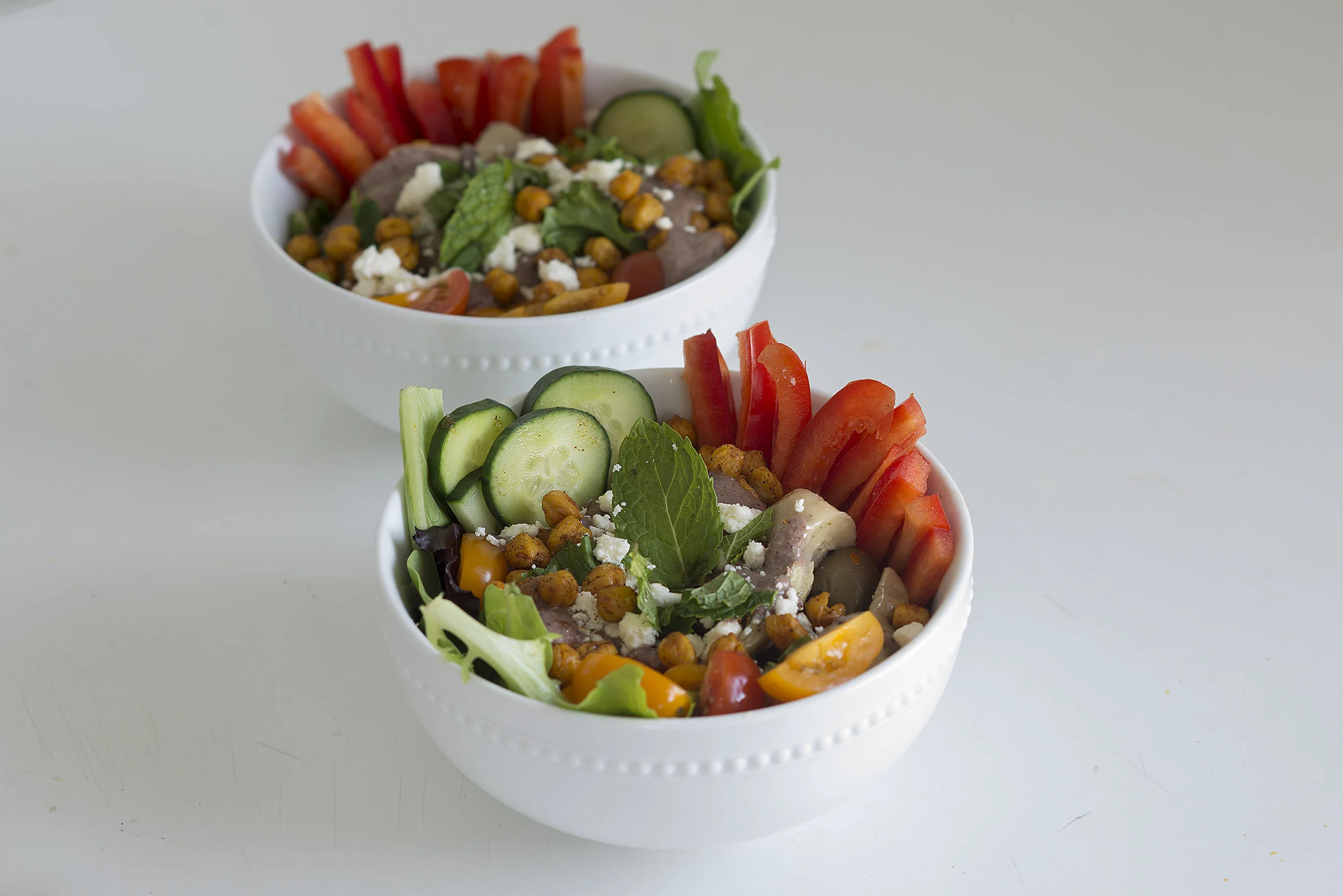 Quinoa Greek Salad with Roasted Chickpeas and Tahini Olive Dressing