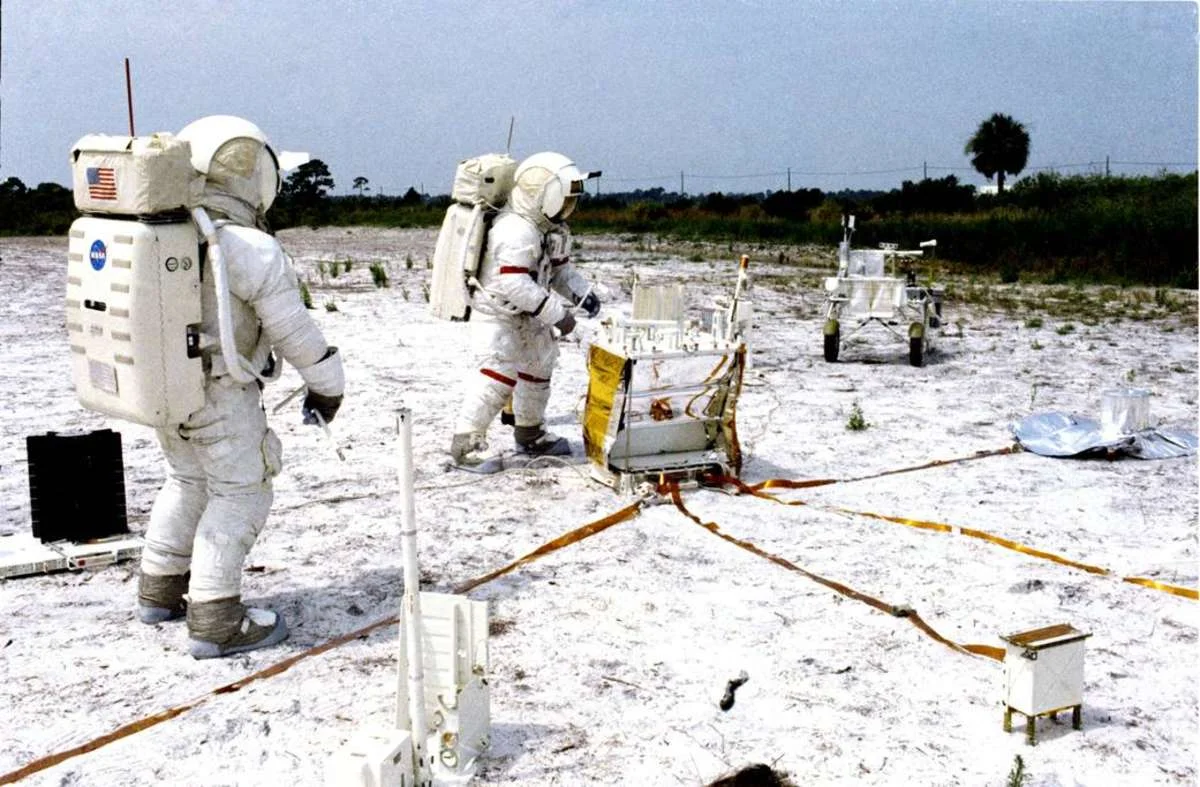Two astronauts with a practice Apollo 14 ALSEP in Houston.
