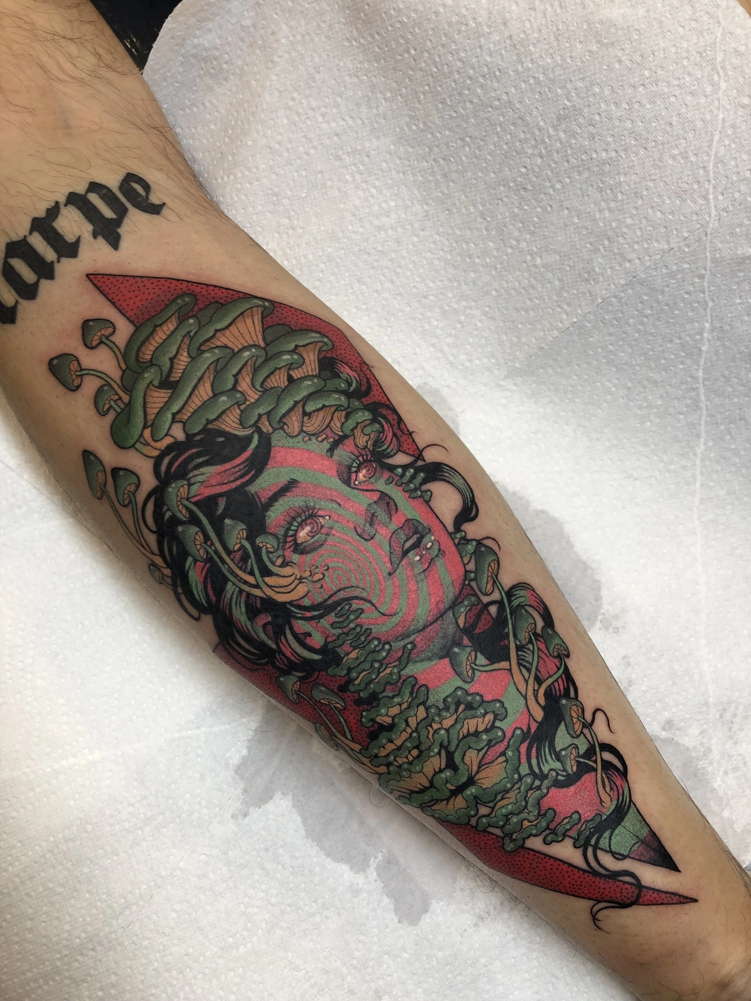 Colourful psychedelic arm tattoo