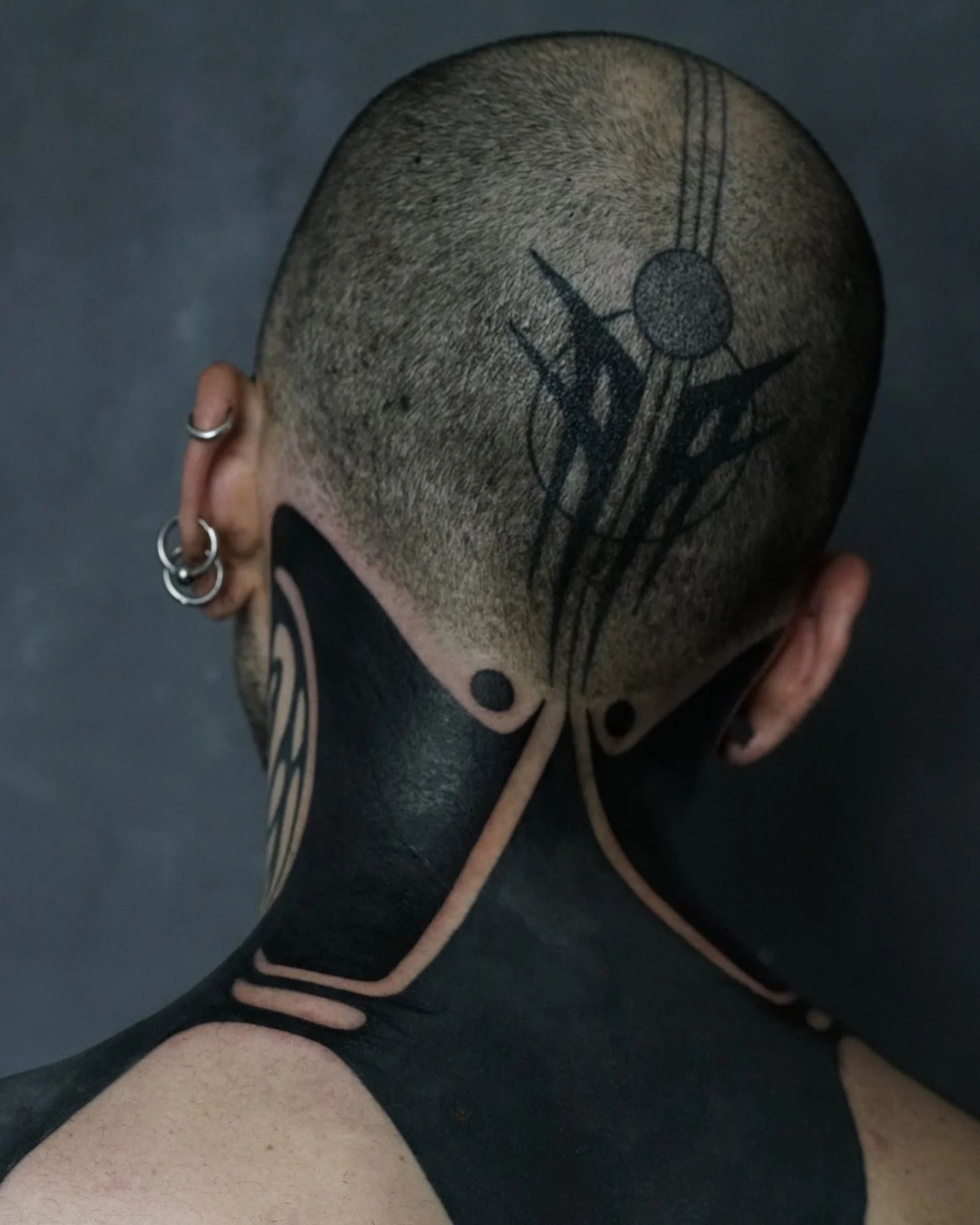 Blackwork tattoo back of neck