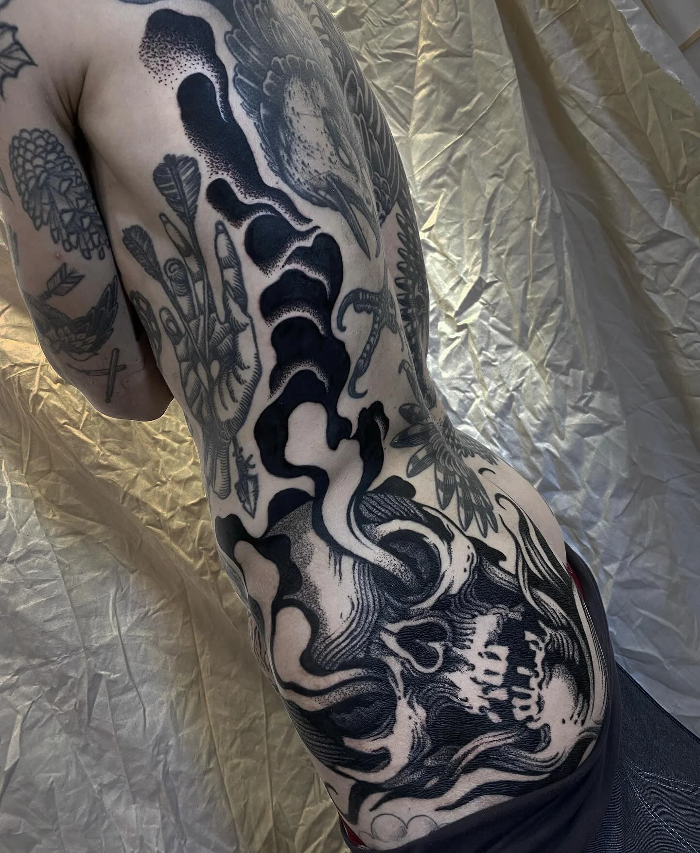 Side torso blackwork skull tattoo