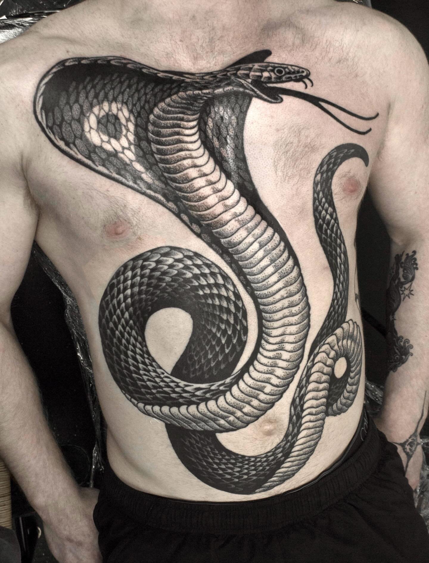 Blackwork cobra tattoo from Red Point Tattoo North London