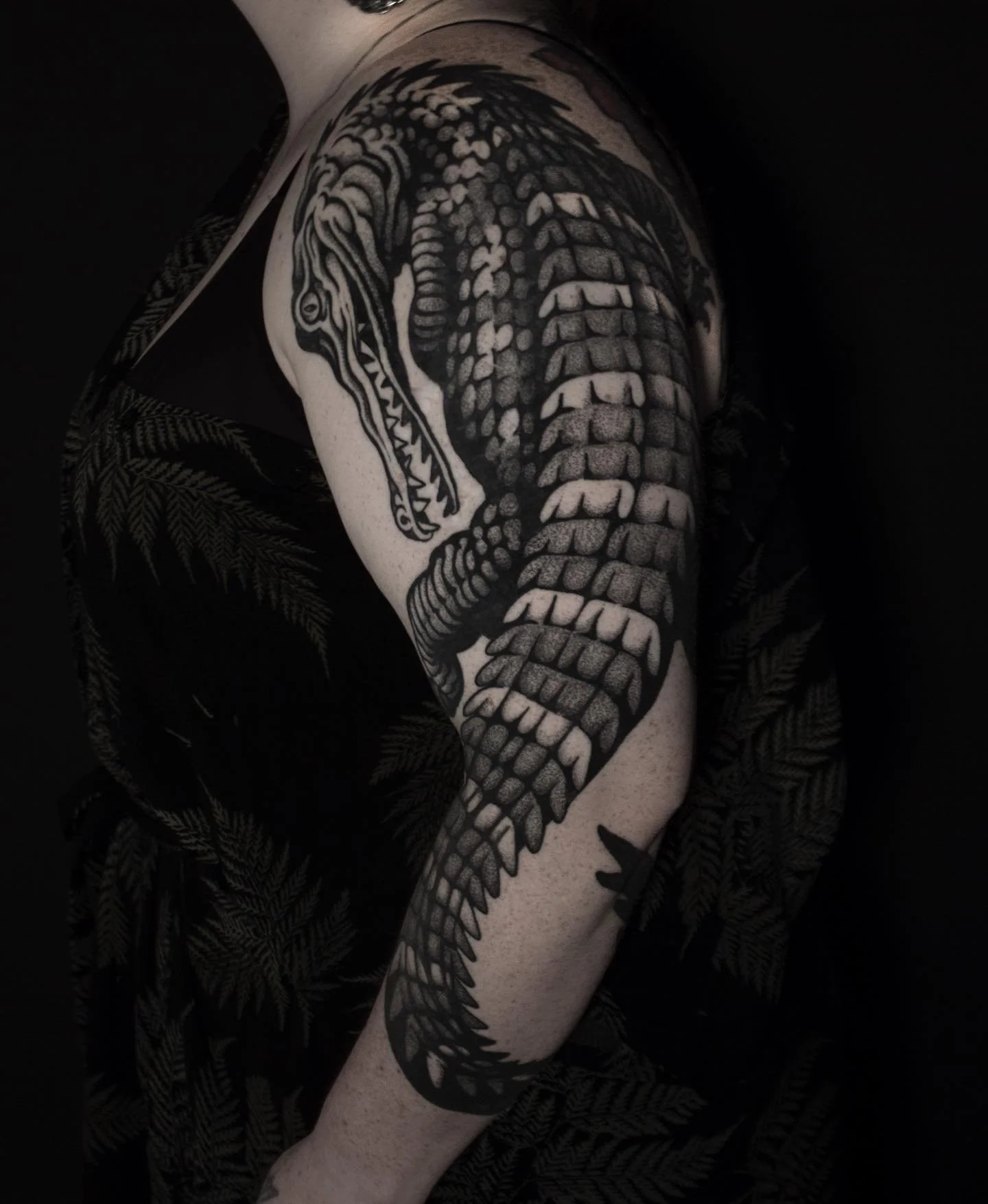 Blackwork crocodile arm tattoo