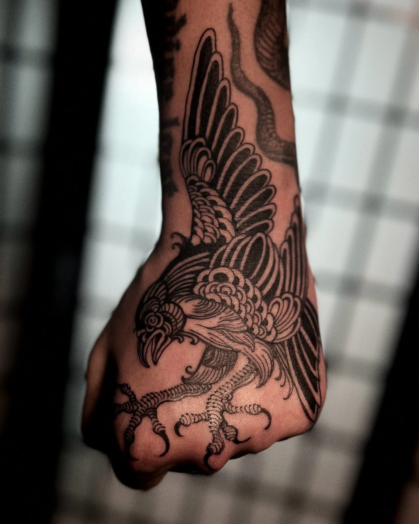 Blackwork bird hand tattoo from Red Point Tattoo in London