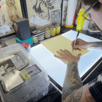 Dan Moreno light boxing a tattoo design