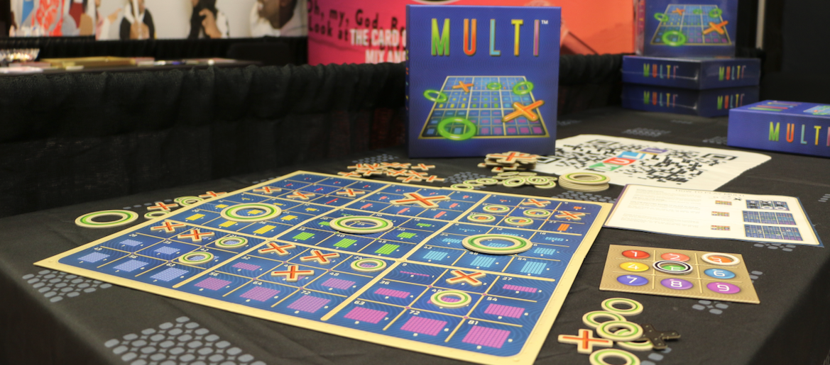 The MULTI game board, showing nine mini tic-tac-toe grids of multiplication arrays with two tokens placed on the factor board on the right.