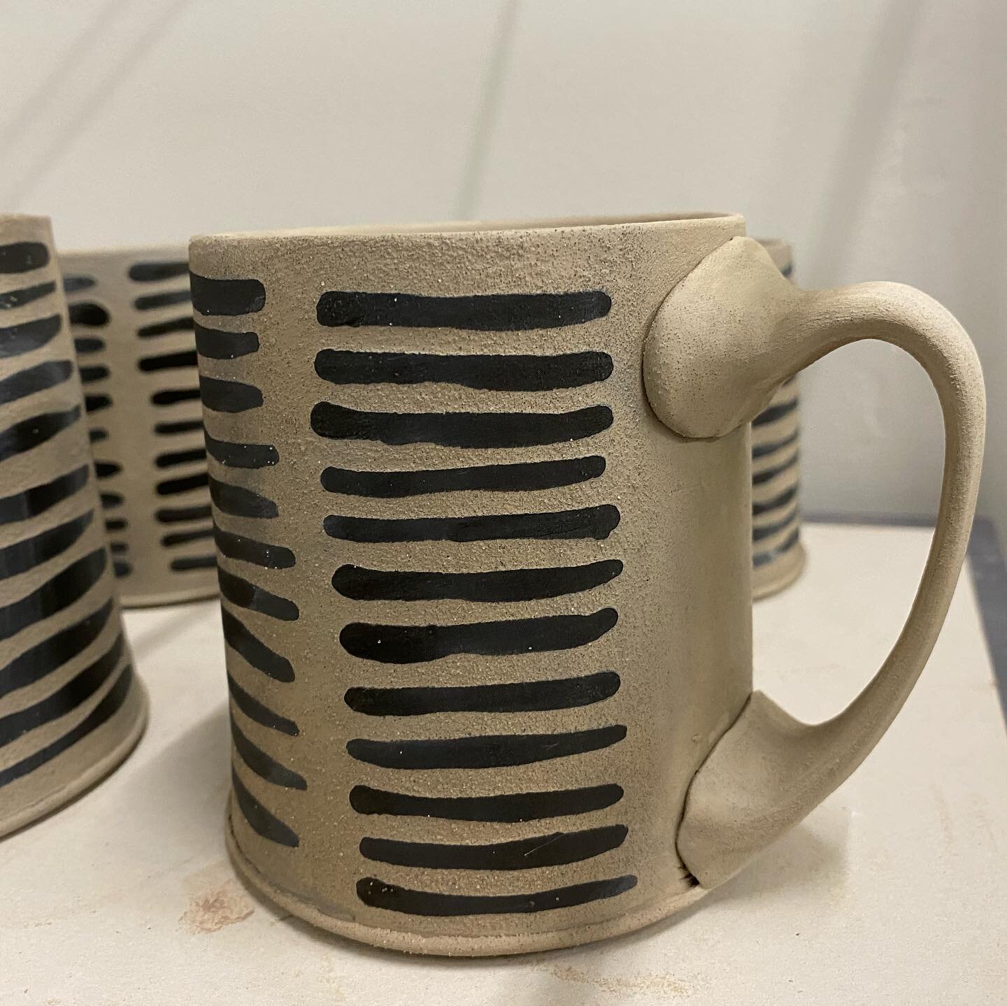 Mugs in progress. Water etching with black underglaze and shellac for some raised surface texture. 
#tobedetermined 
#clay #mugs #pottery #function #wip #wateretched 
#midwestclayproject