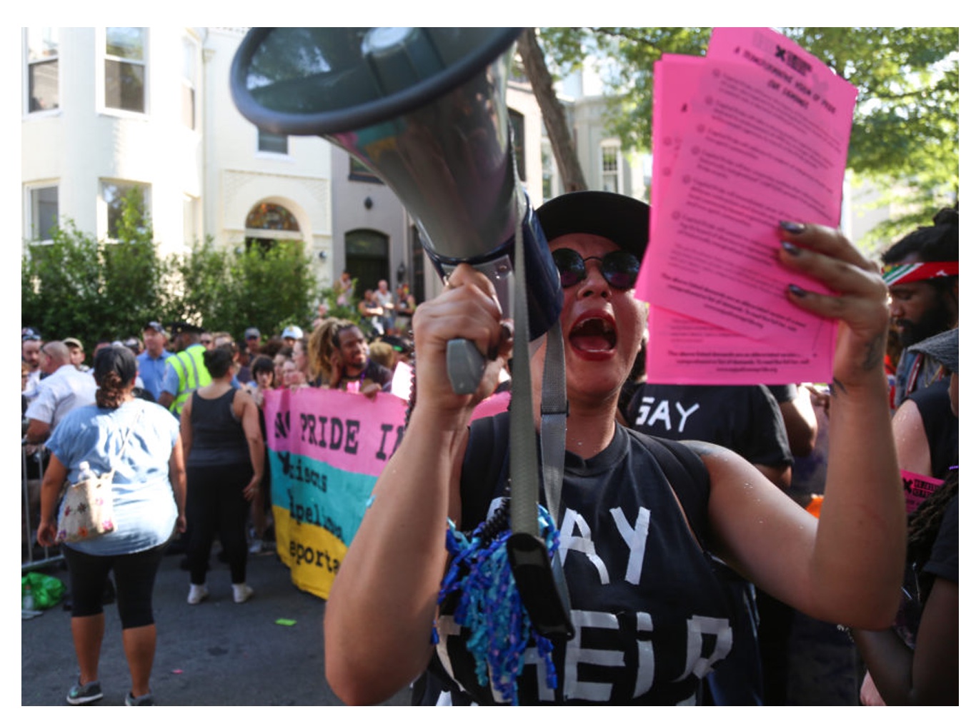   No Justice No Pride action with local organizers. Ale reads community demands as they shut down the Metro Police float.  