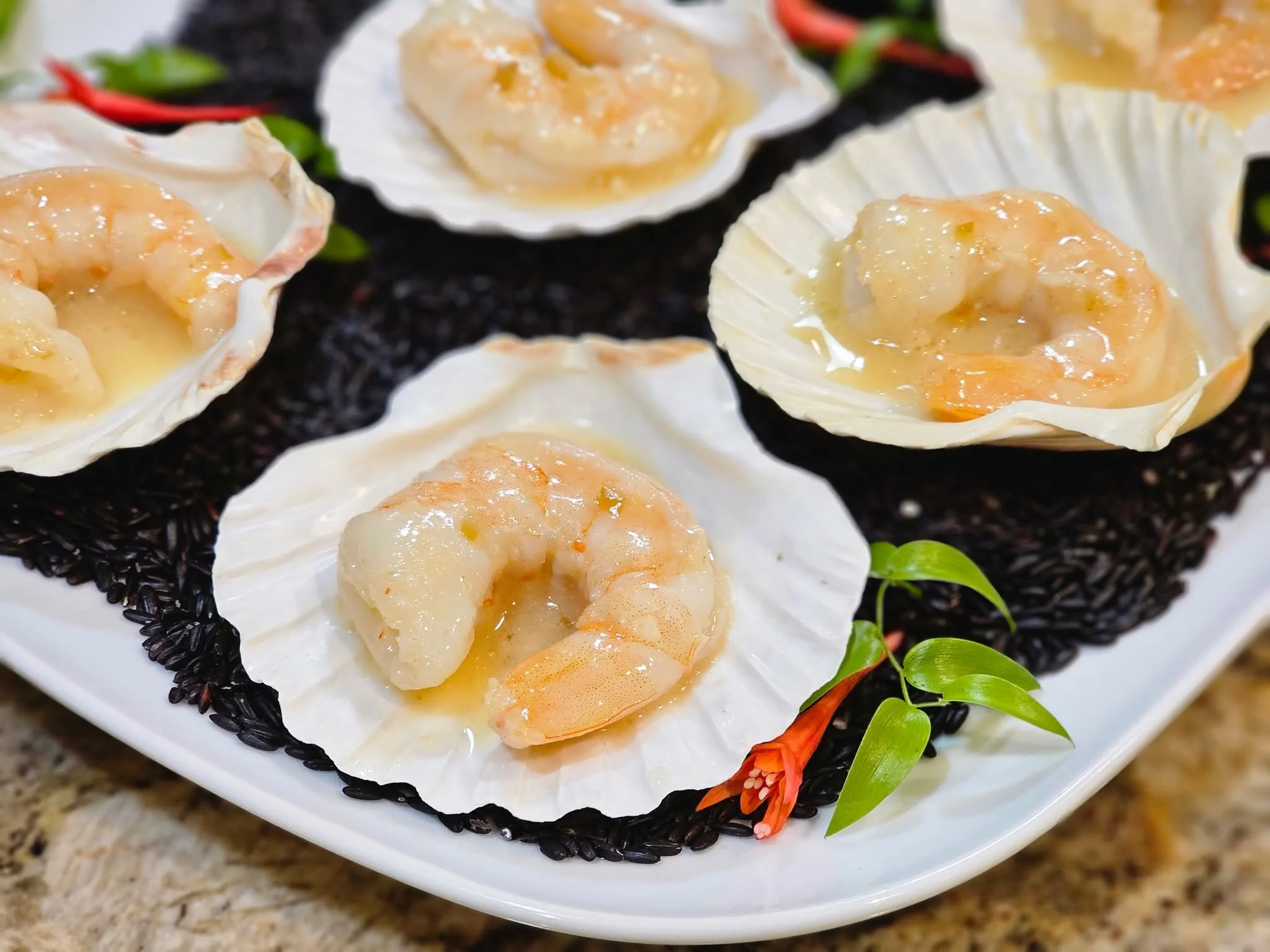 This dish doesn’t whisper luxury — it shouts it.
Poached shrimp in citrus butter, served in scallop shells like edible jewels.
A little heat. A little silk. A whole lot of "holy sh*t this is good."
These one-bite wonders are w