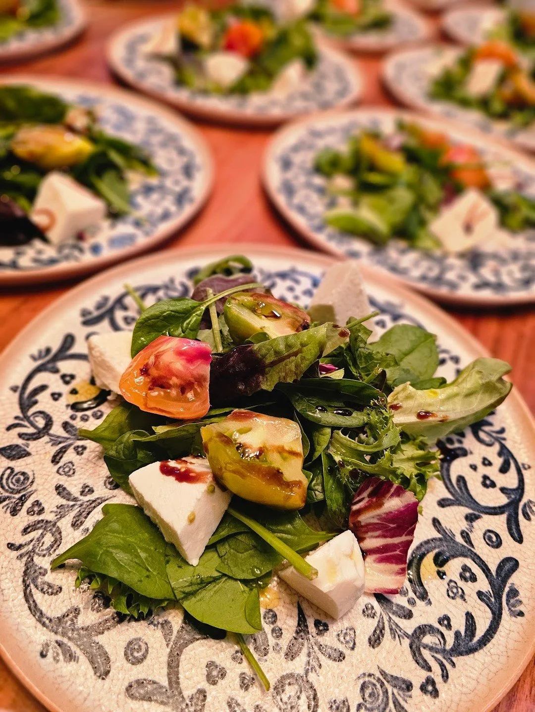 Clean. Crisp. Colorful. This salad proves you don&rsquo;t have to compromise flavor for freshness.
Heirloom tomatoes, creamy feta, and that perfect balsamic drizzle. A bright beginning to any celebration.

🥂 New year, new menu. Let us design your ev