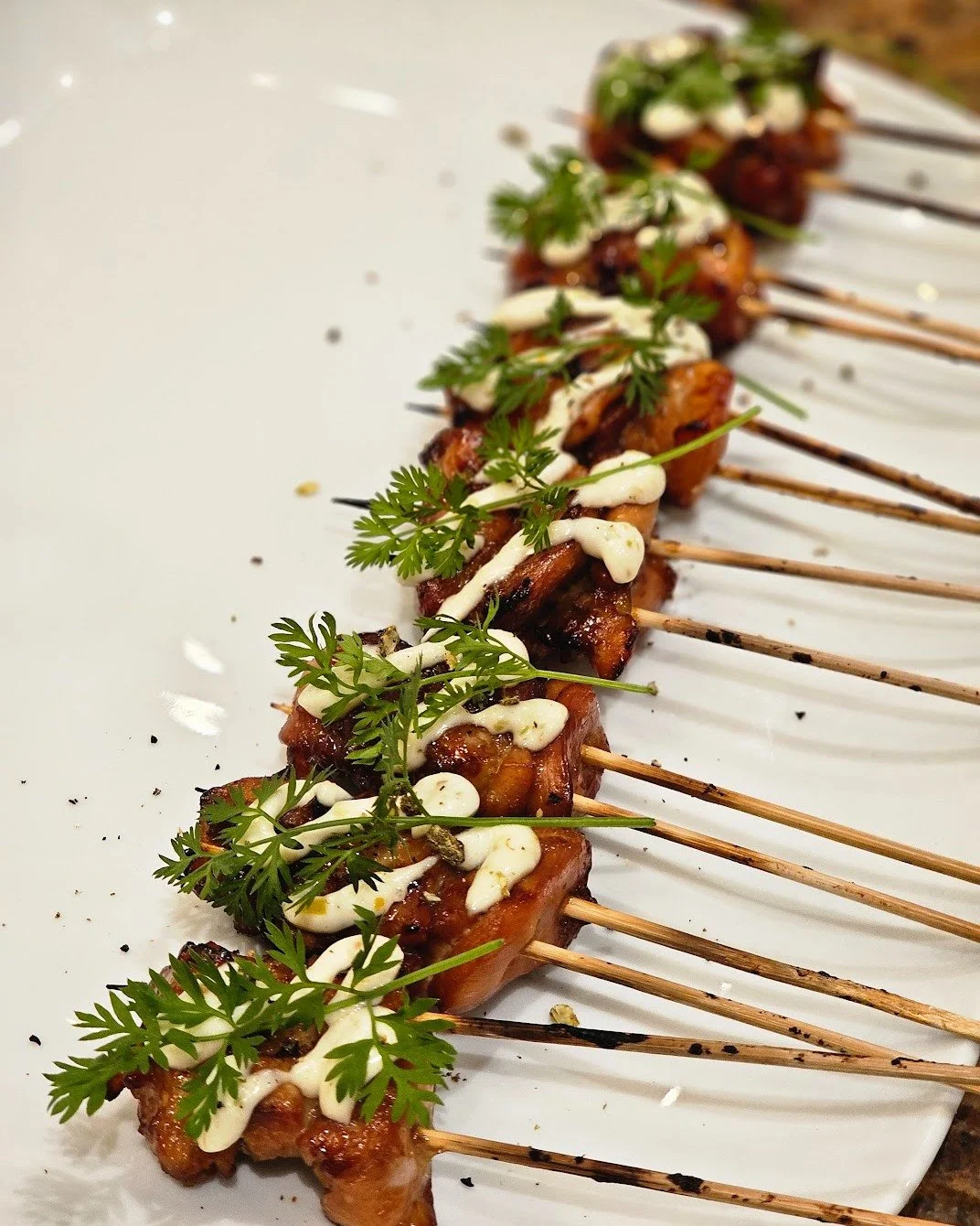Simple ingredients. Elevated execution.

Perfectly grilled, finished with a creamy herb sauce, and served with just enough flair to make guests ask for seconds.

These aren't your average party skewers.

They're the reason people linger by the appeti