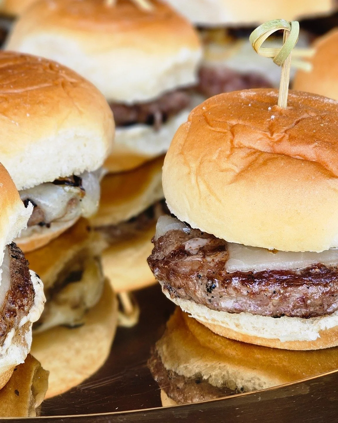 Sometimes the simplest things are the biggest crowd-pleasers.

Juicy beef sliders topped with melted cheese and perfectly paired toppings create the ultimate handheld bite for weddings, corporate events, and private parties.

Small sandwich. Big flav