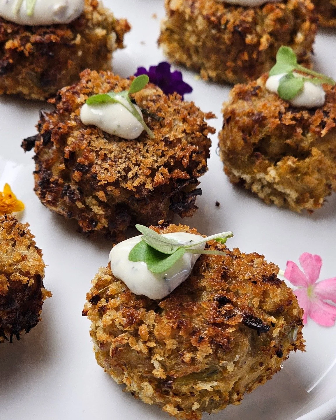 Crab Cakes with Herb Aioli

Golden, crispy, and packed with flavor.

Our handcrafted crab cakes are finished with a creamy herb aioli and elegant garnishes for a bite that's equal parts comfort food and fine dining.

Perfect for cocktail hours and up