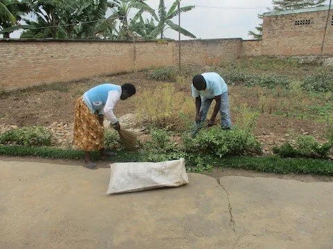 September rain has begun. Workers prepare a field for planting.