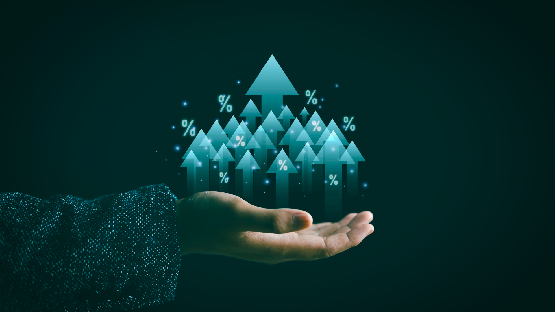 A person's hand holding holographic arrows pointing upward, with percentage signs (%) around them, symbolizing growth or increase.